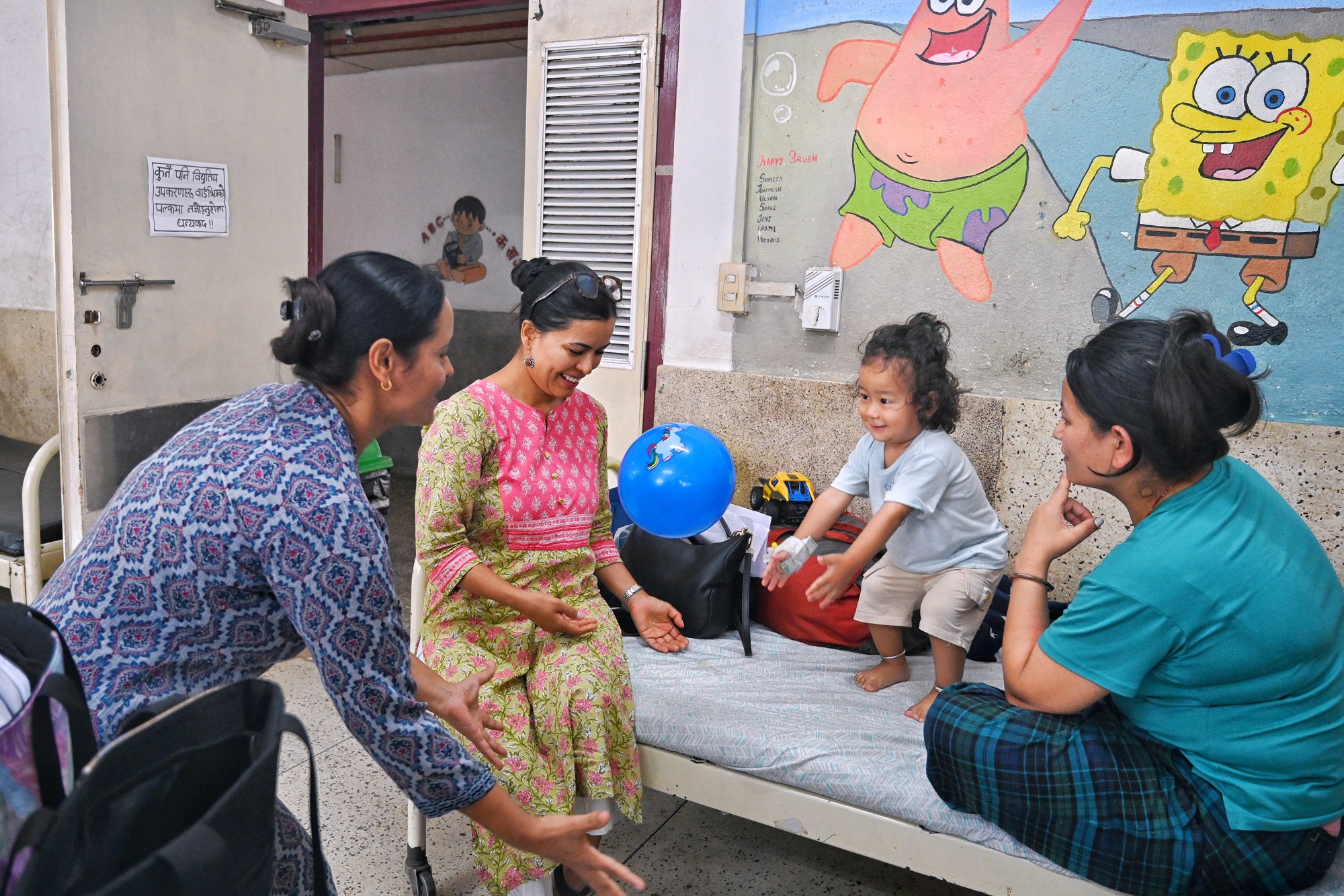 A participant (left) engages in interactive play with a child as part of Child Development Course at Kanti Children’s Hospital, Nepal.