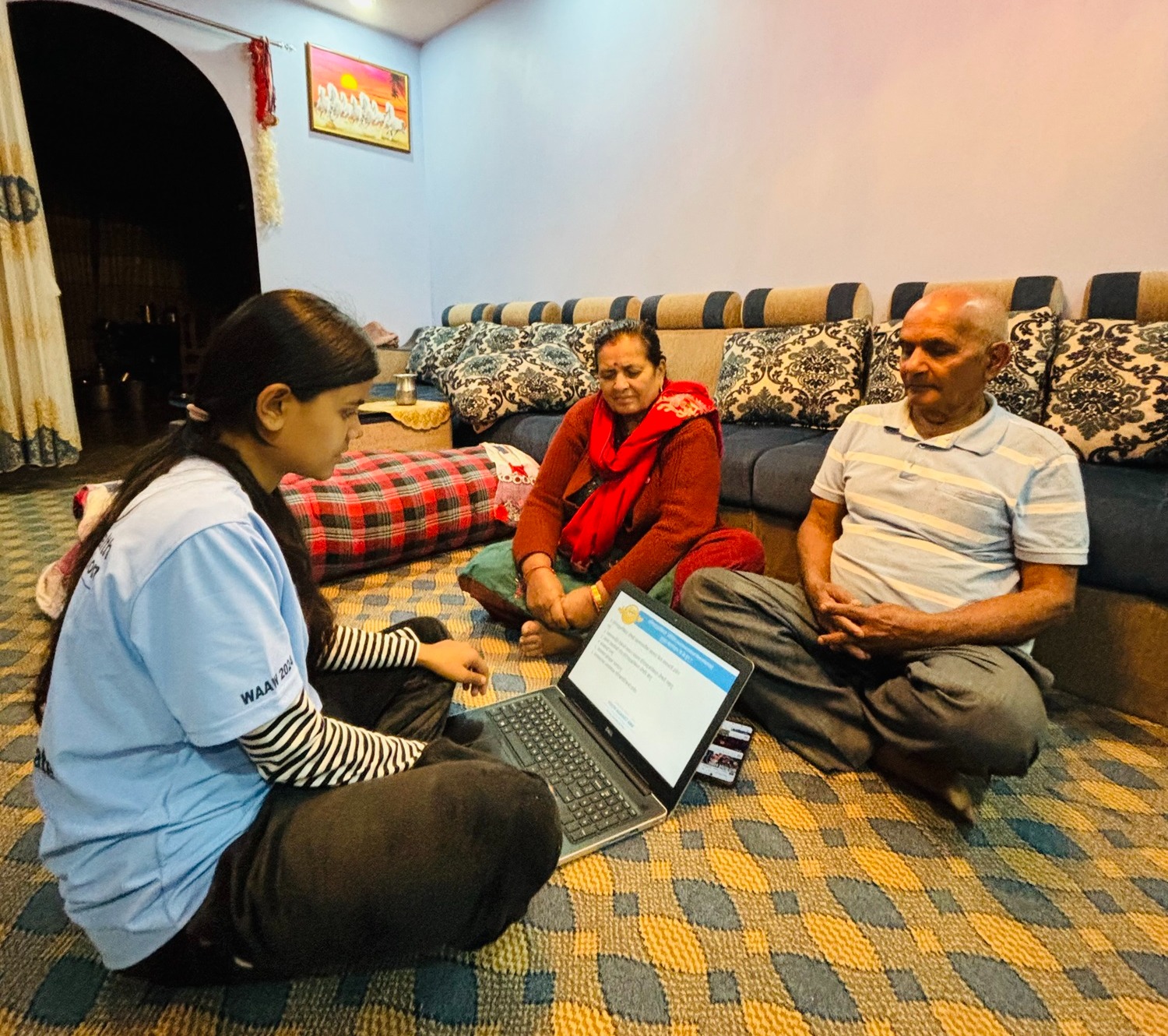 A daughter sitting across her mother and father and briefing them on antimicrobial resistance