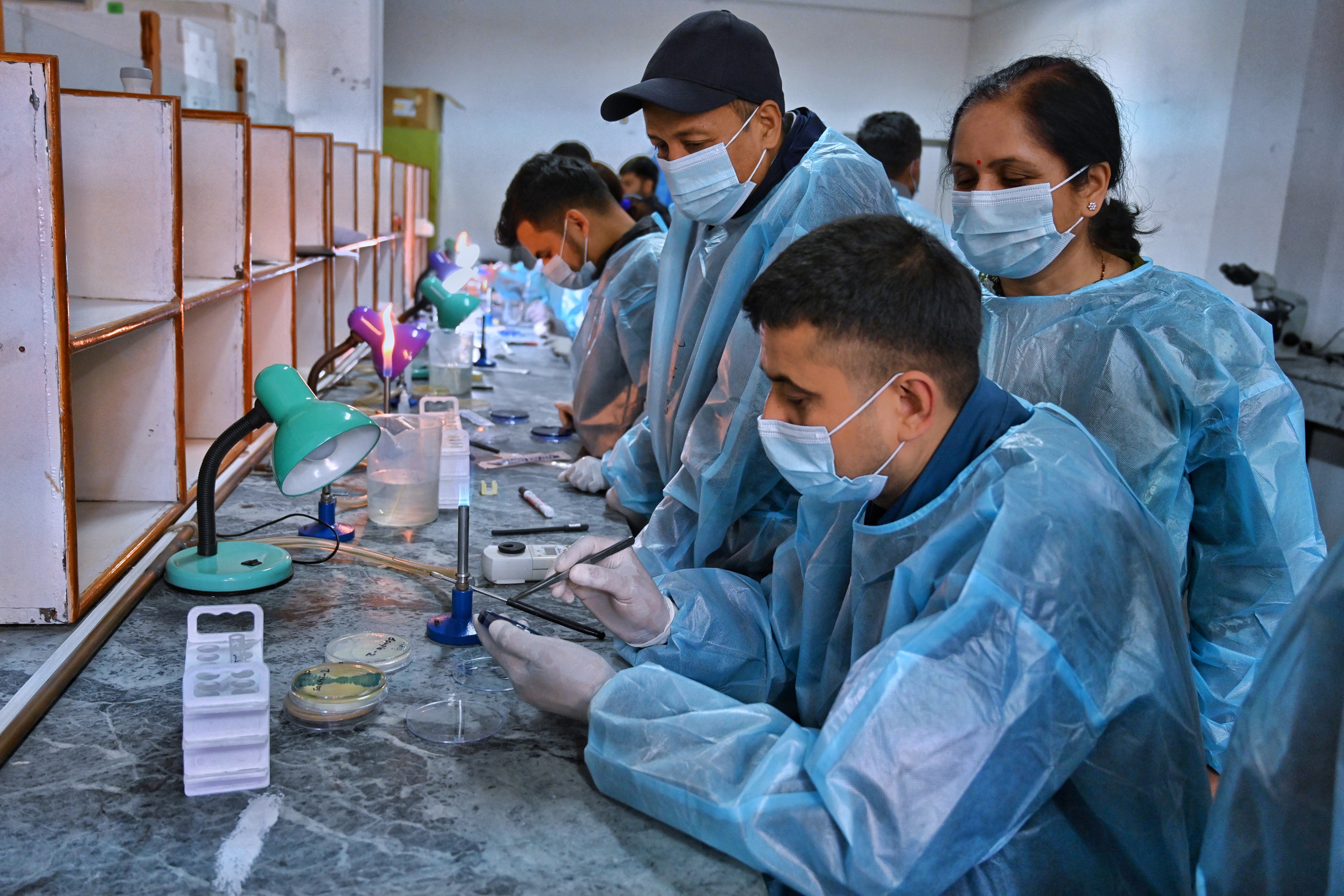 A facilitator (middle) supervising trainees during the training on basic mycology culture and Antifungal Susceptibility Testing (AFST) for laboratory workers held in Bagmati province, Nepal