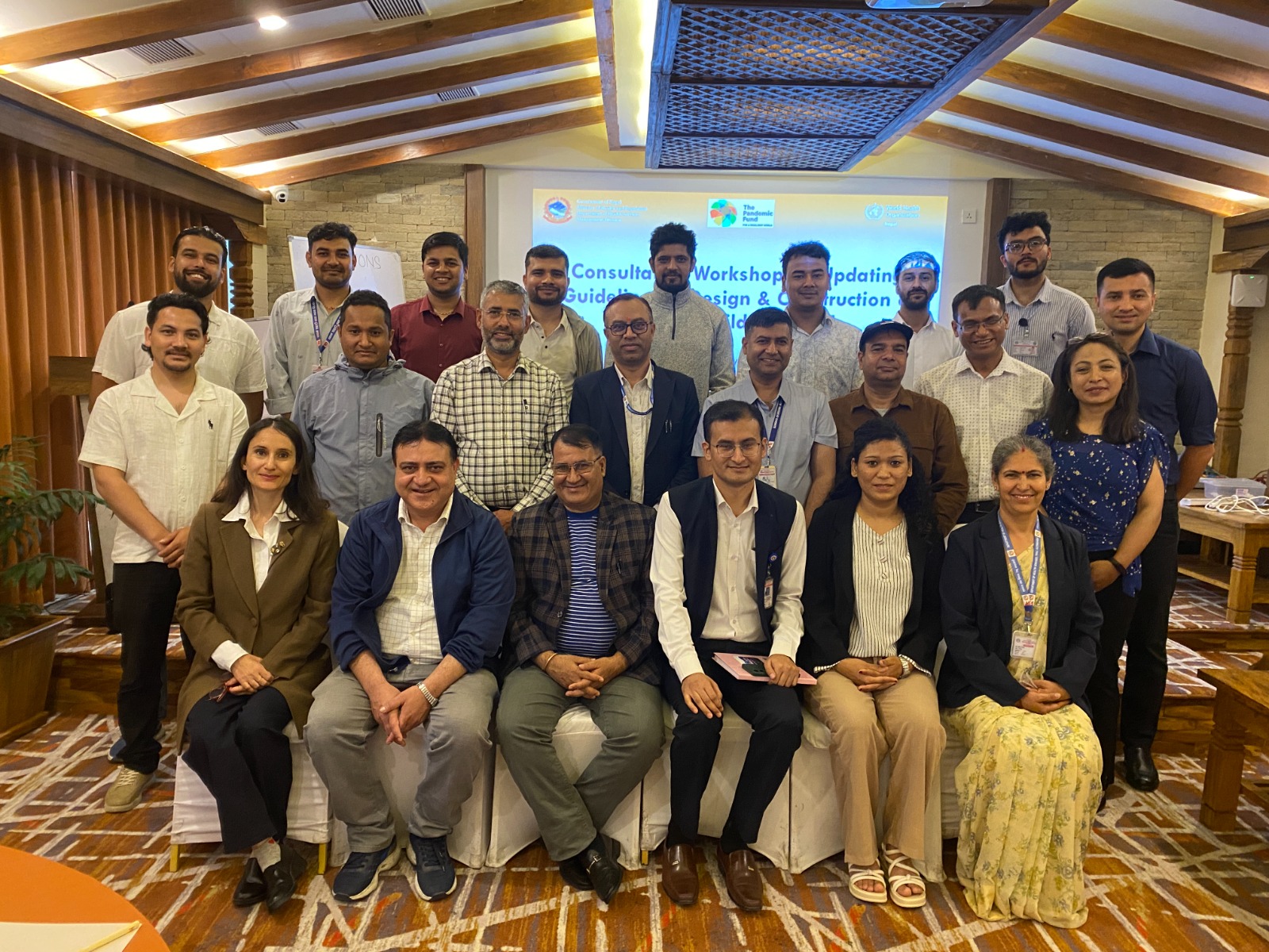 A group photo of the participants present at the consultative workshop on updating guideline for design and construction of Nepal's health building held in Gandaki province, Nepal