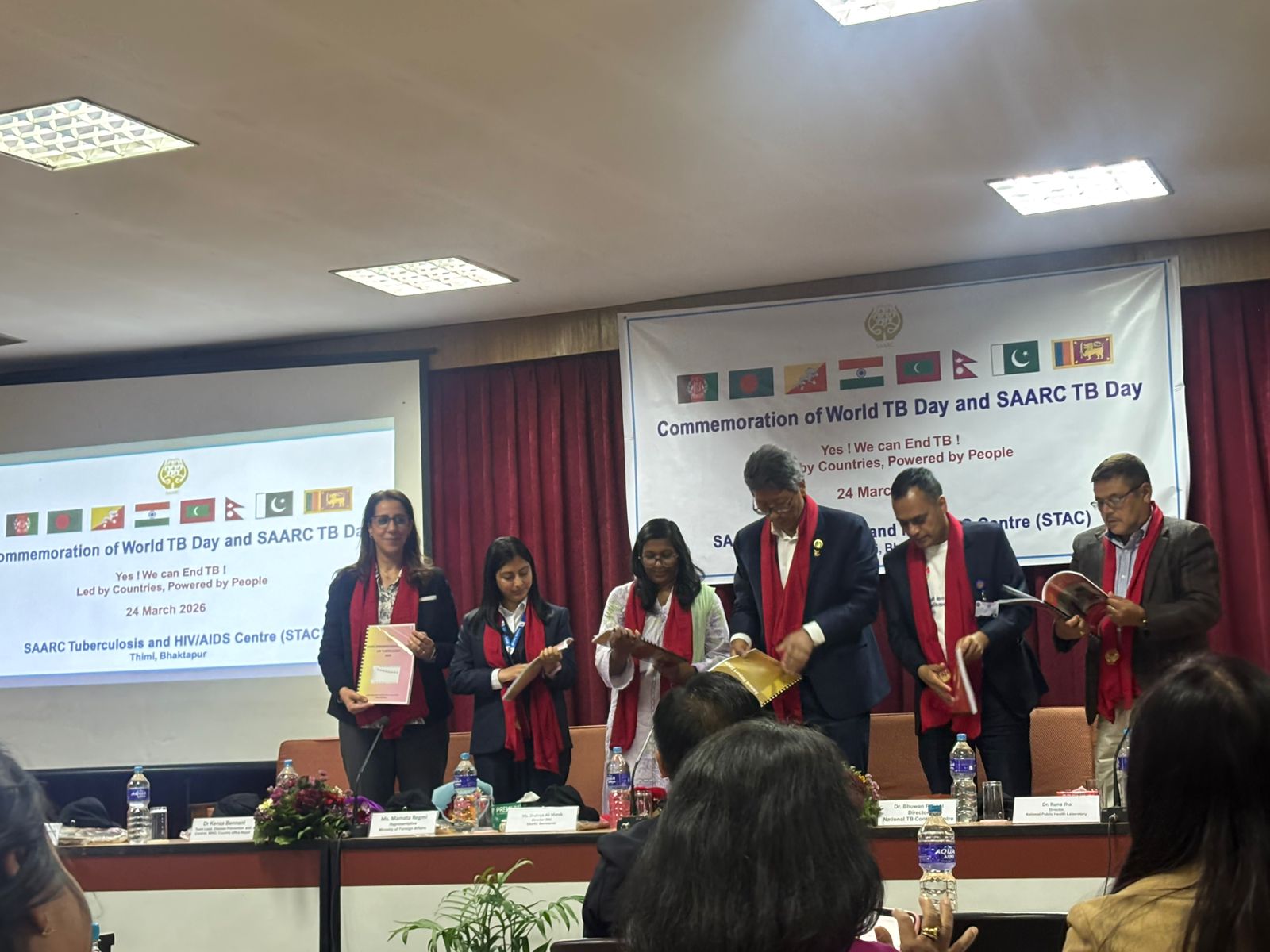 Dignitaries on the stage unveiling the STAC publication during World Tuberculosis Day 2026 commemoration in Bagmati province, Nepal