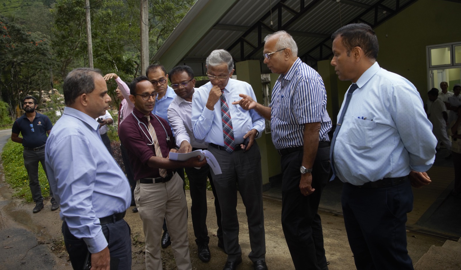 A group of people looking at a report and having a discussion