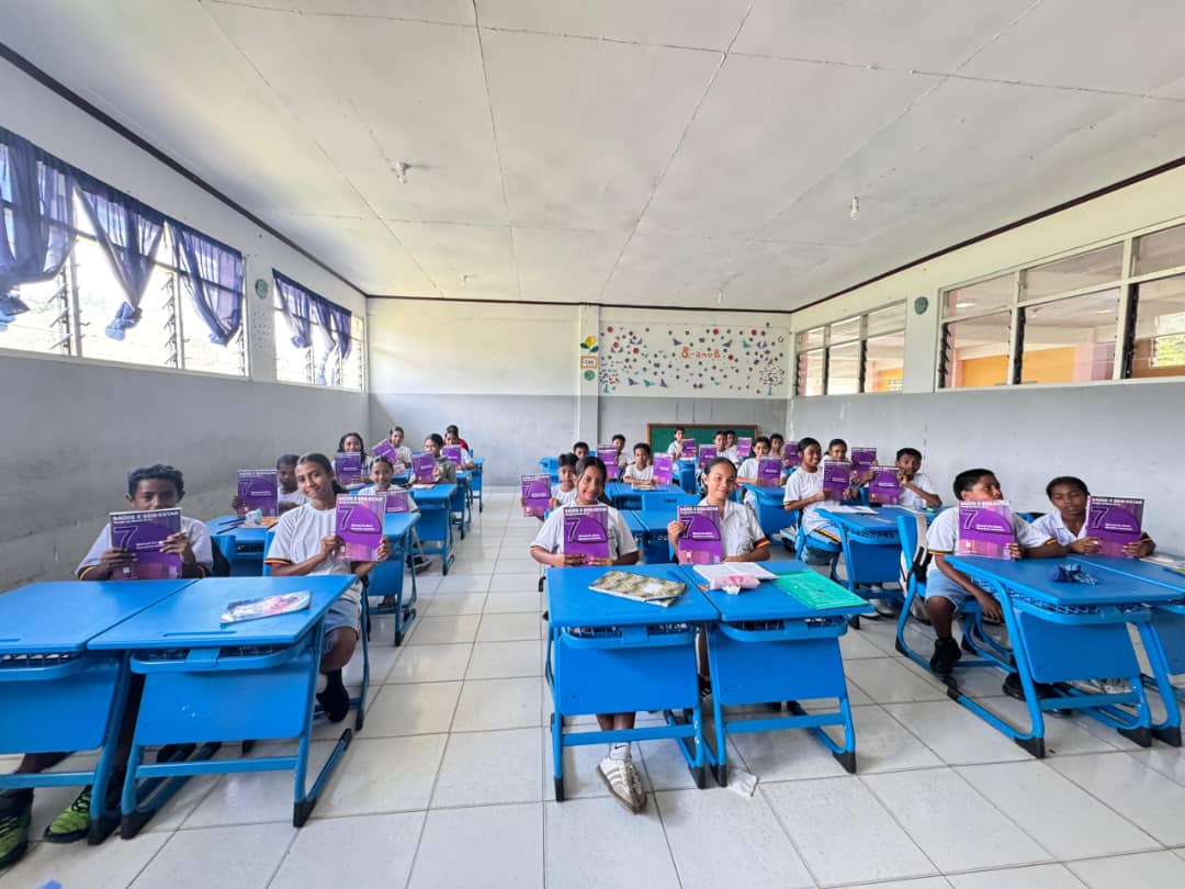Children posing with the new textbooks