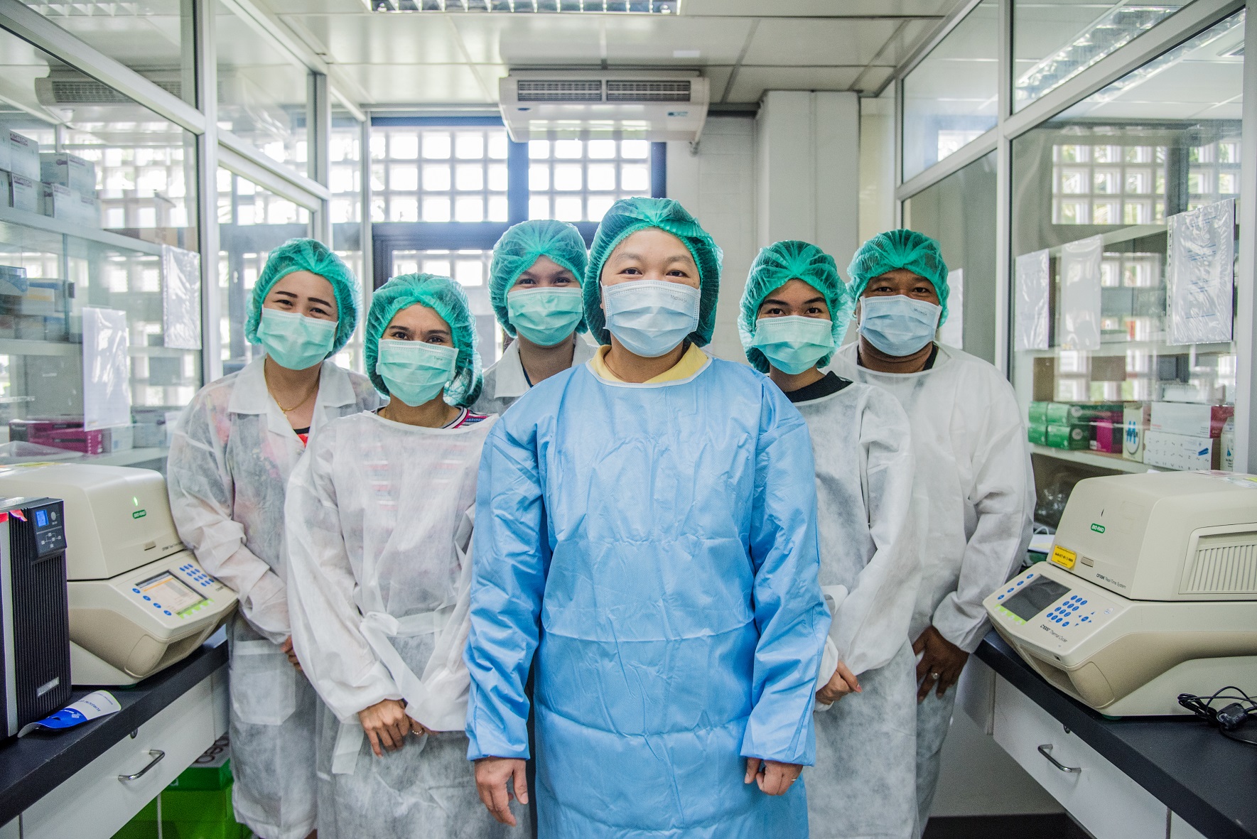 Dr. Pilailuk Okada (front), the head of the National Influenza Centre at the Thai National Institute of Health and her team of microbiologists. 