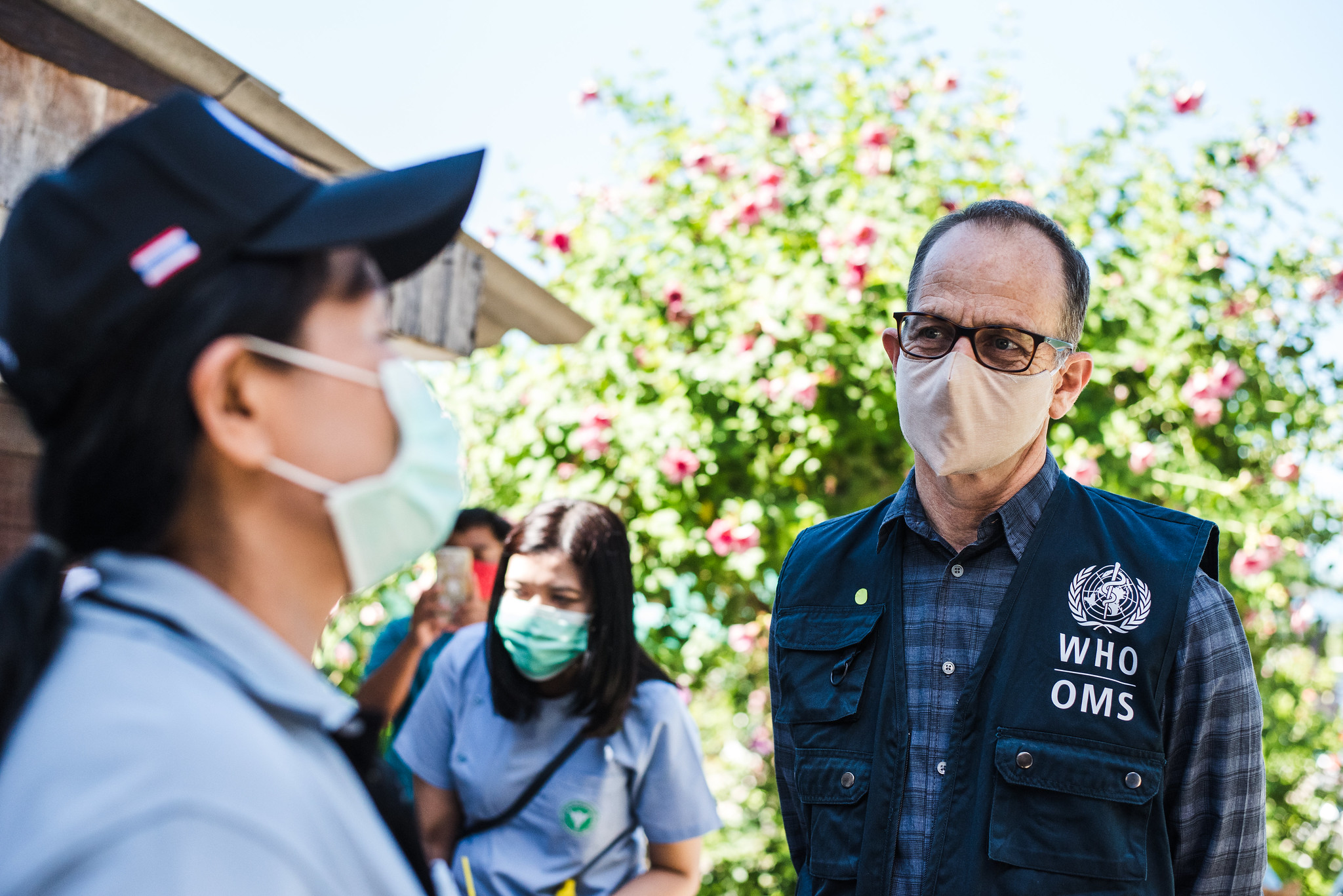 Dr. Daniel Kertesz, WHO Representative for Thailand, WHO Thailand Country Office at Koo Bang Luang Sub-District Primary Care Center, speaks with health volunteer