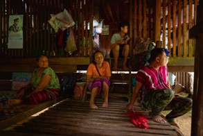 Panaeloi sits among a Karen family in their home in Huai Hom village, exemplifying the deep bond and trust shared between health workers and the Karen community they serve.© WHO 2023