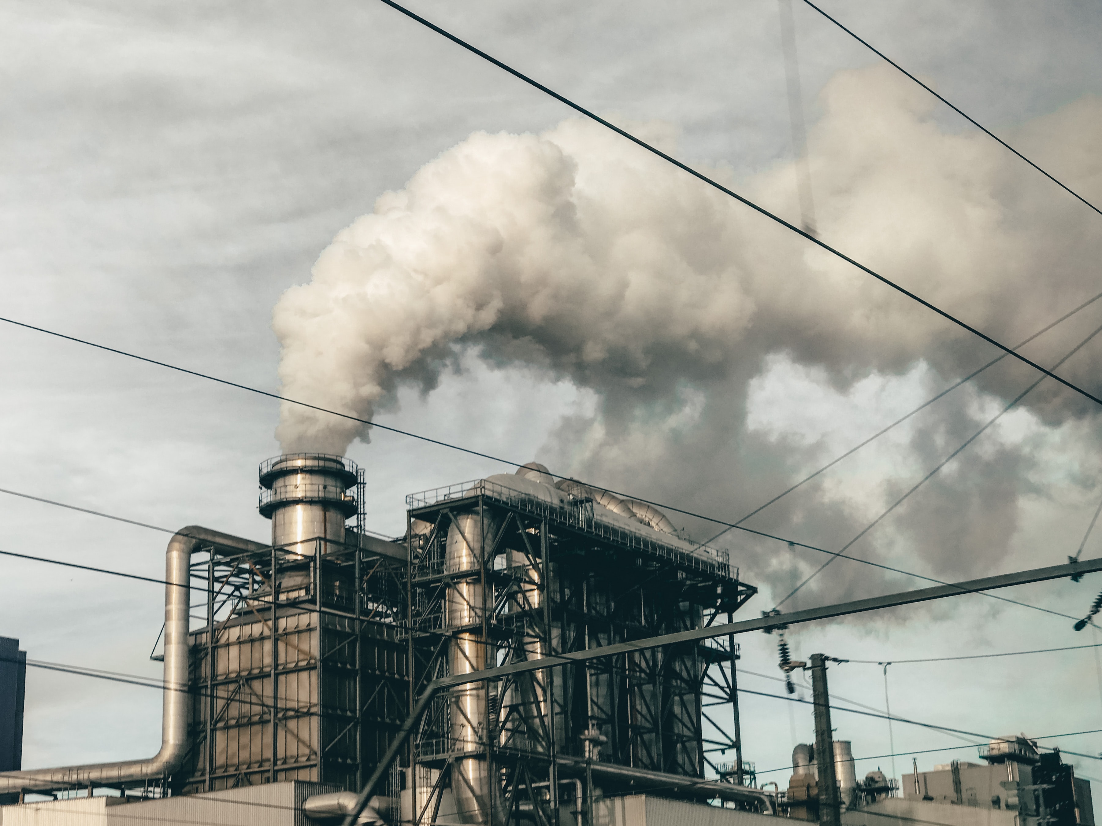 Industrial chimneys by Jeremy Bishop on Unsplash