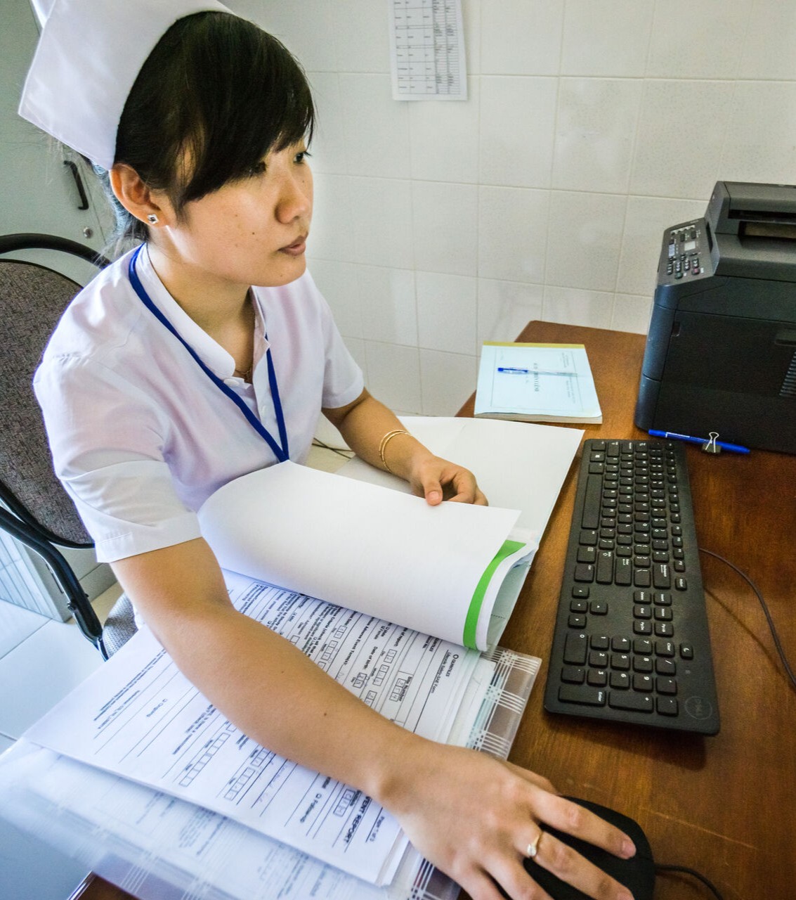 health worker at a computer