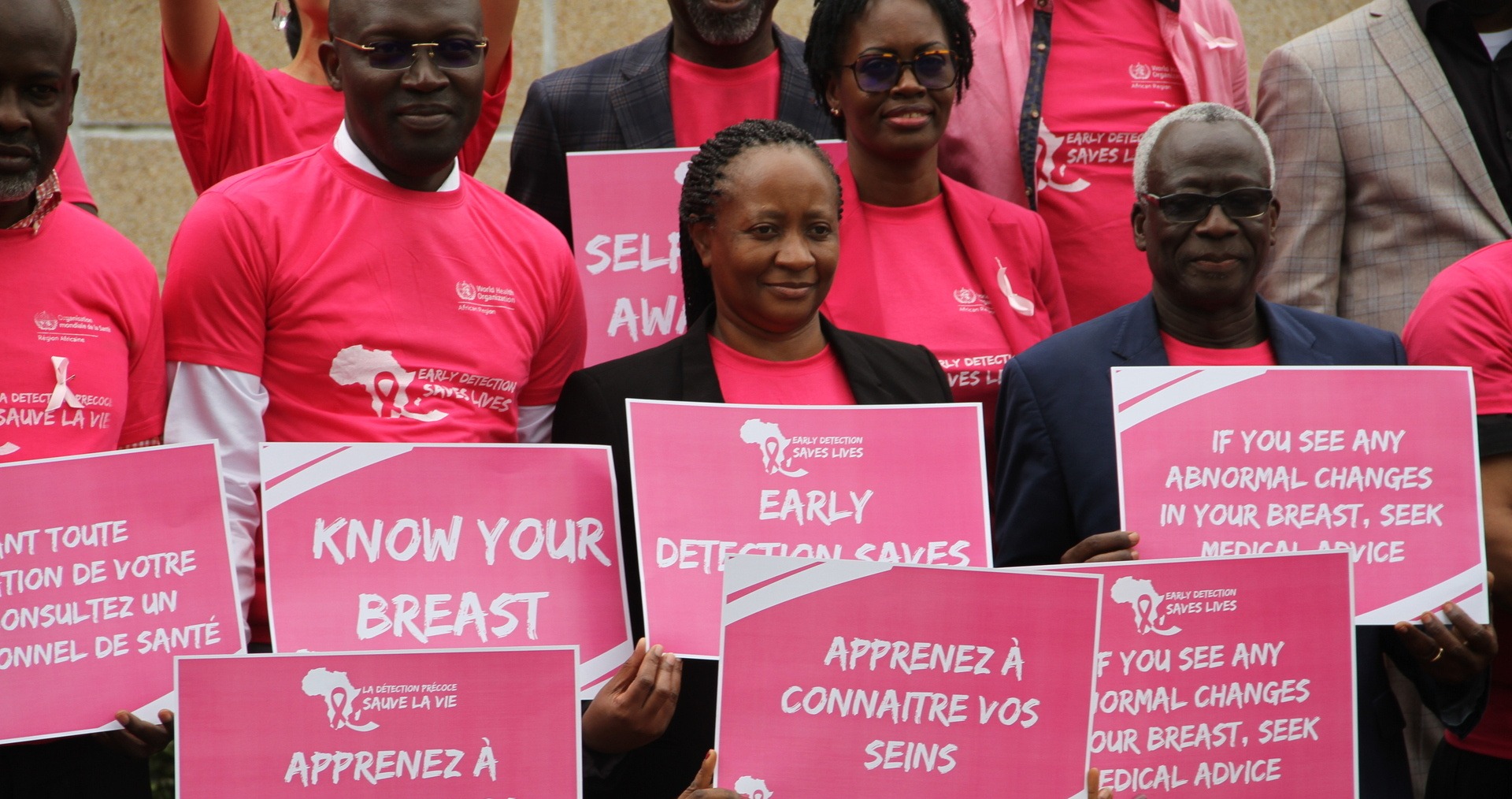 Breast cancer A group of people holding signs to raise awareness against breast cancer