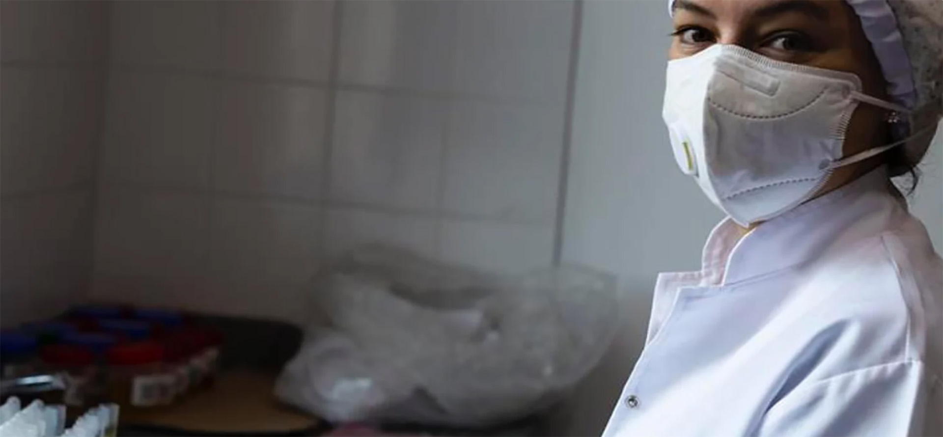 A health worker wearing a white mask.