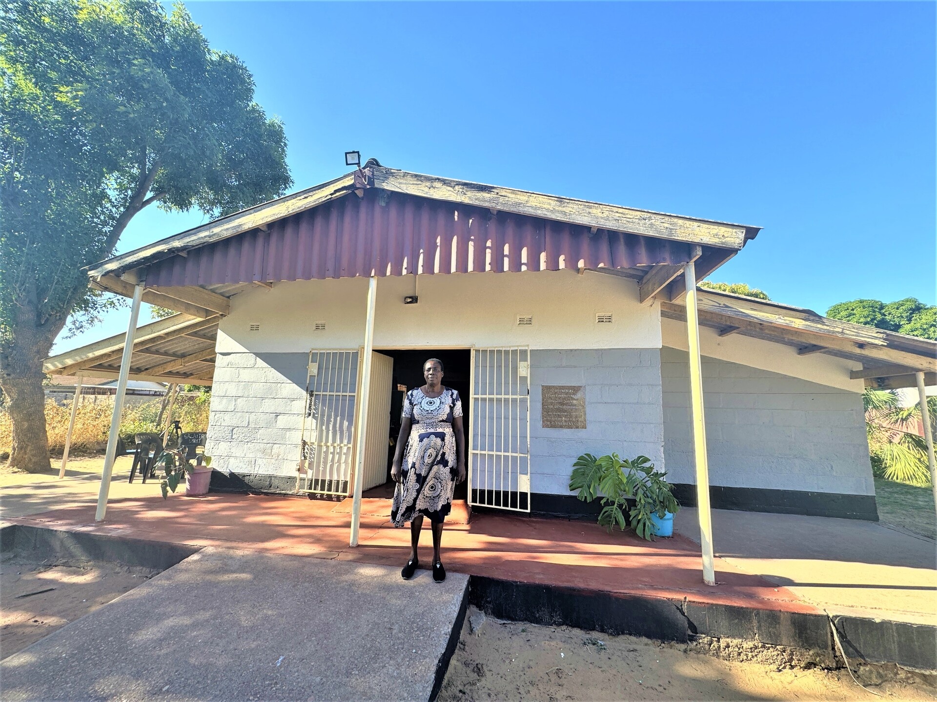 A woman standing outside a youth community centre.