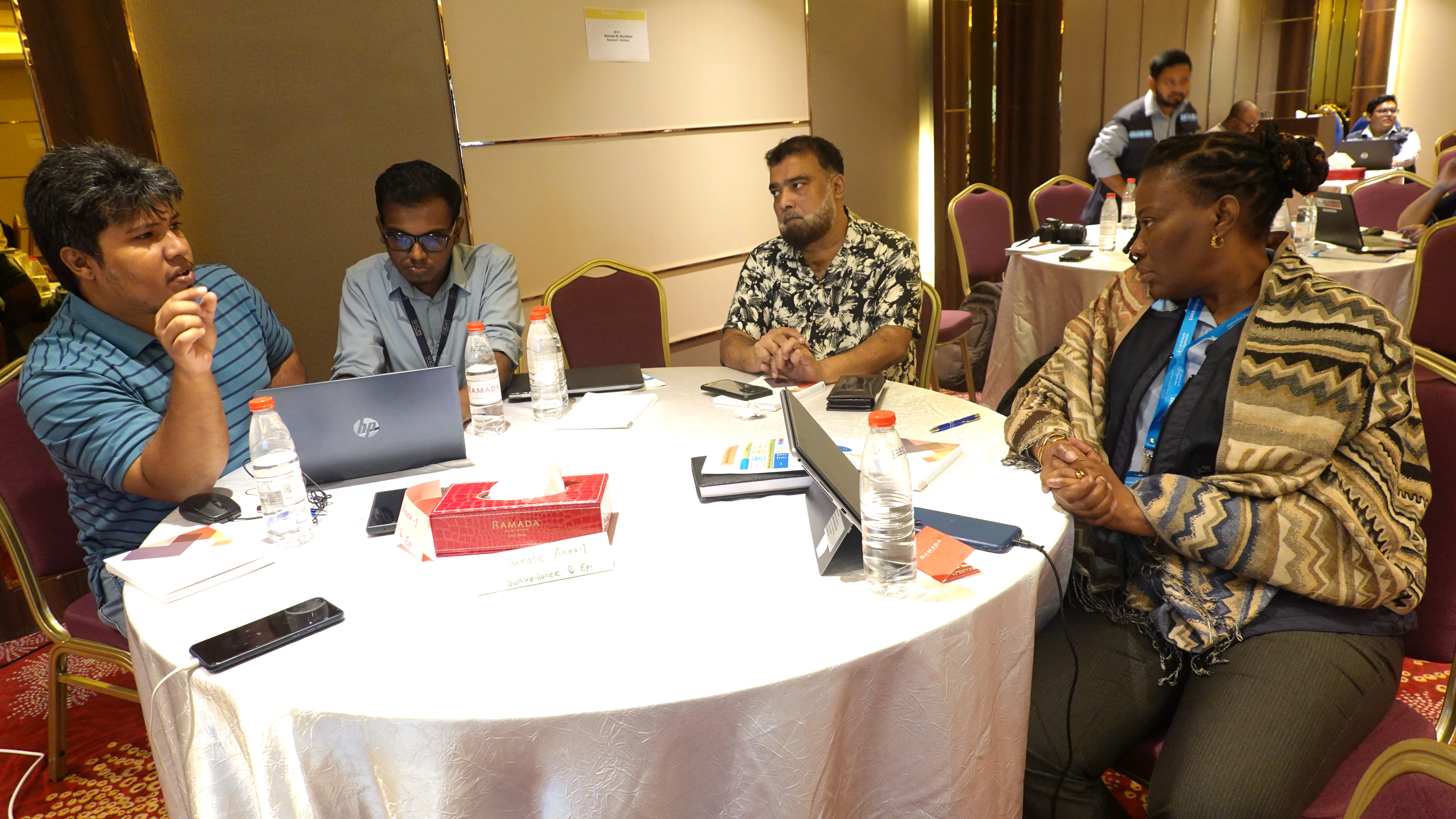 Participants working together in a group discussion to design cholera outbreak response strategies in Cox’s Bazar