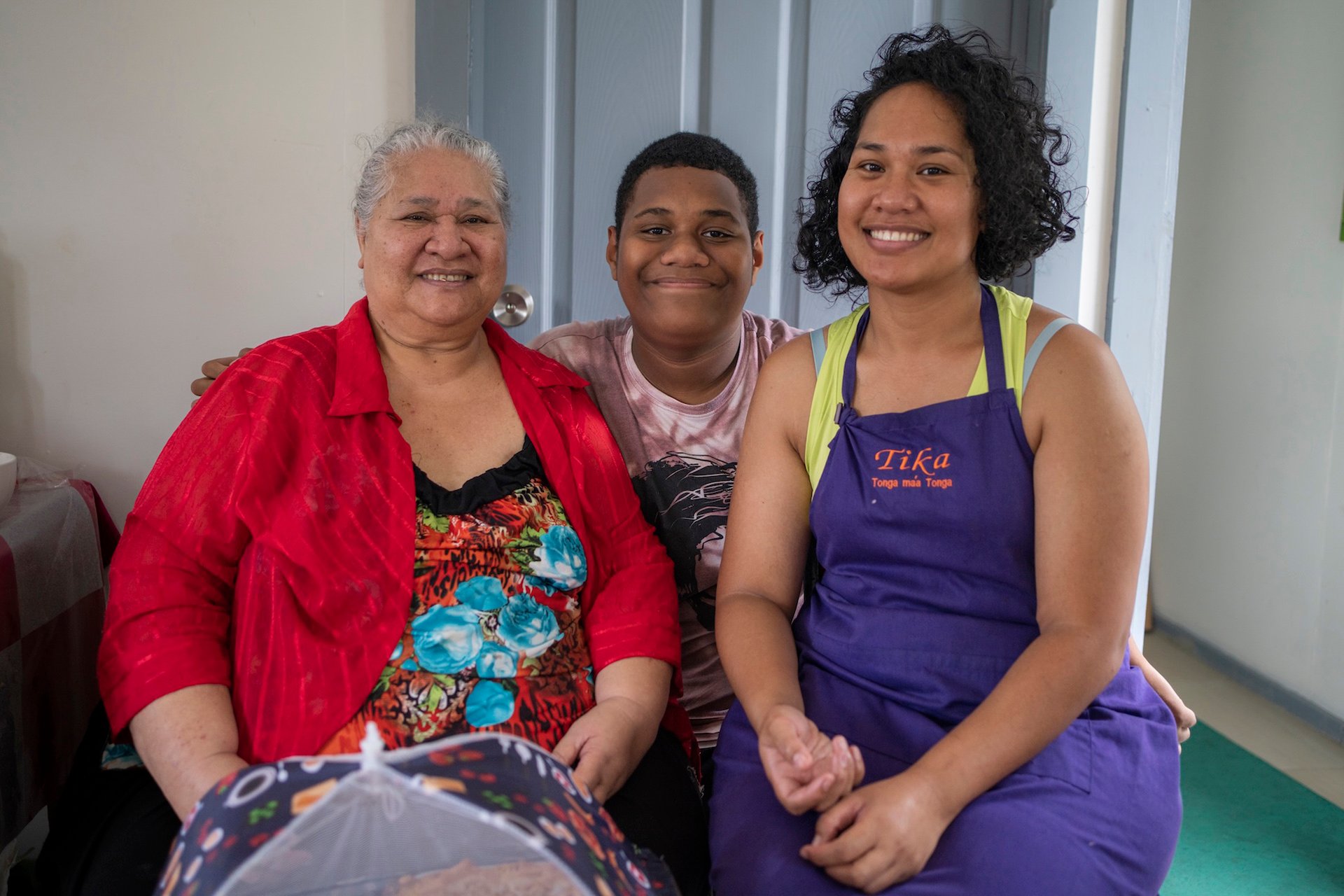 Family portrait in Tonga Two women and a teenager boy are sitting and smiling