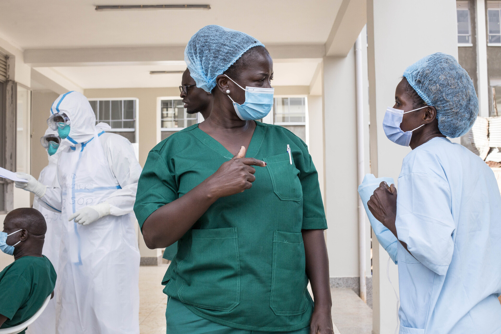 A nursing officer talks with a hygenist at an Ebola treatment centre.