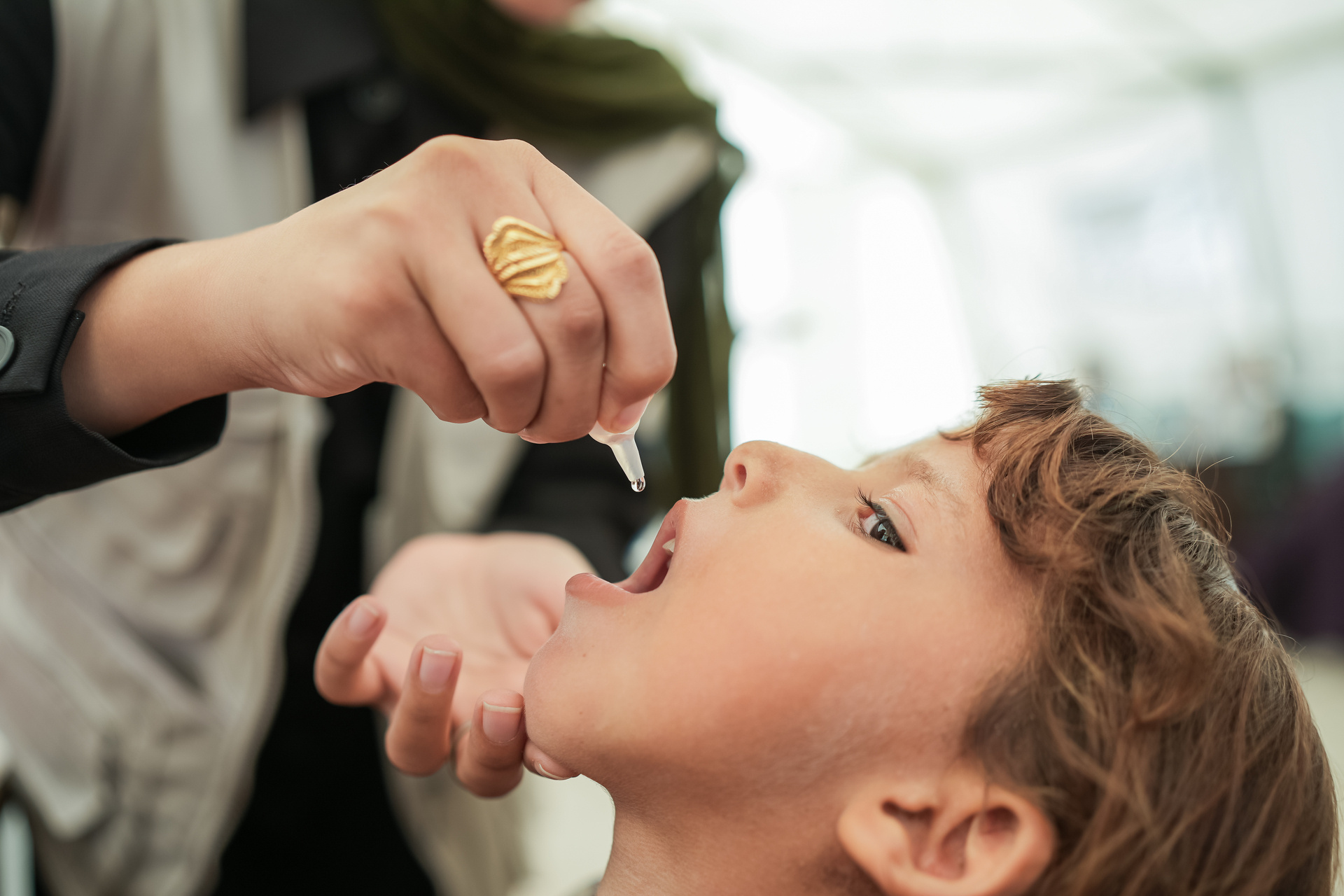 child receiving polio vaccine Child receiving oral polio vaccine