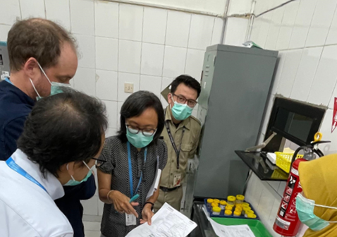A team of tuberculosis epidemiological review team in Setiabudi community health centre in Jakarta. A woman is pointing to a paper document, surrounded by three men and one woman, discussing about TB recording in the facility.