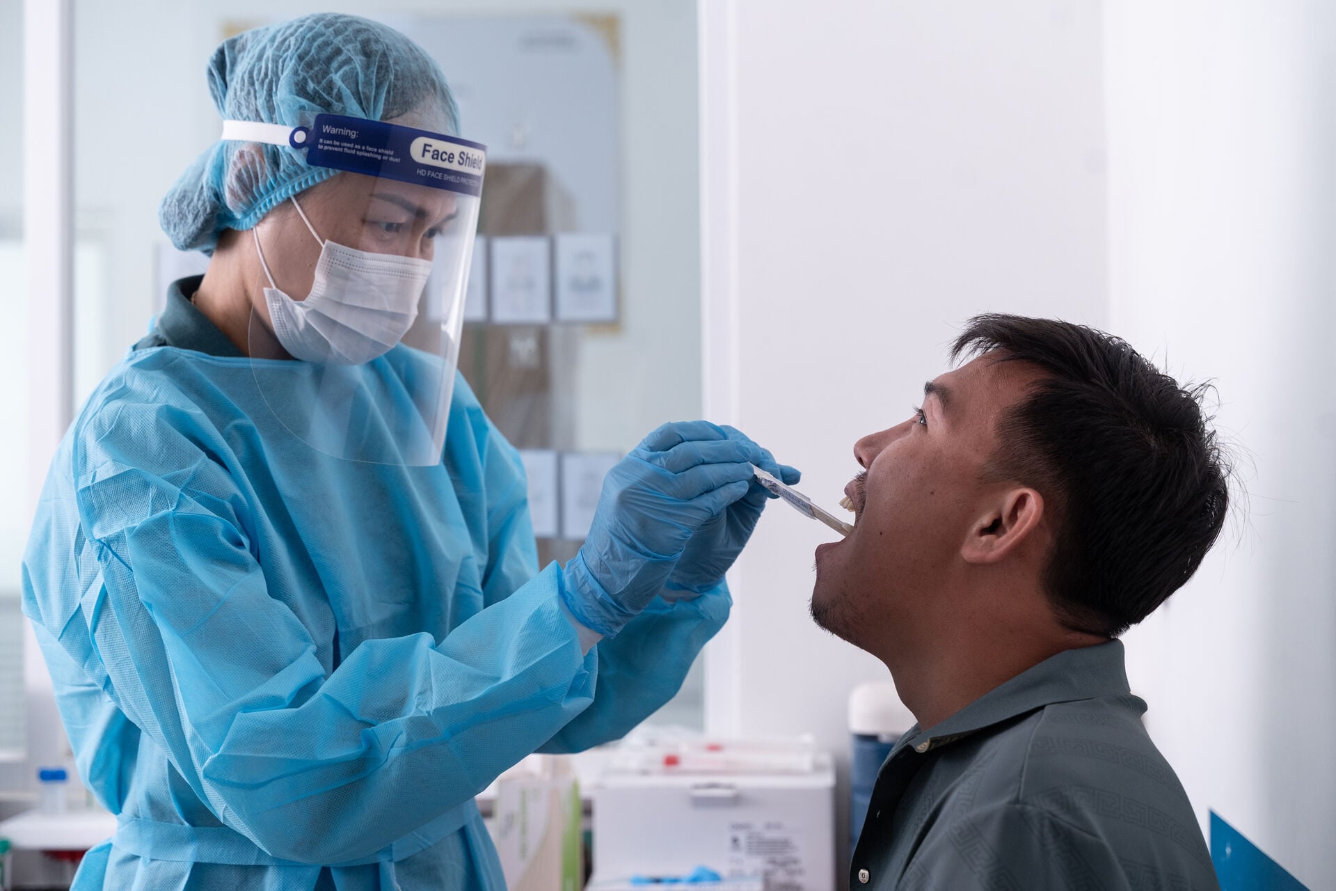 A laboratory technician is collecting samples from a patient's mouth