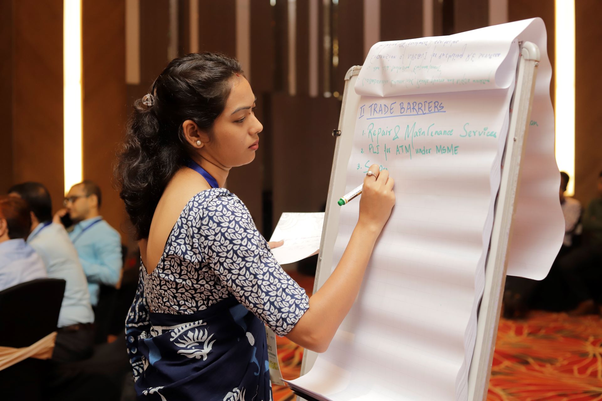 A woman writing in a white board