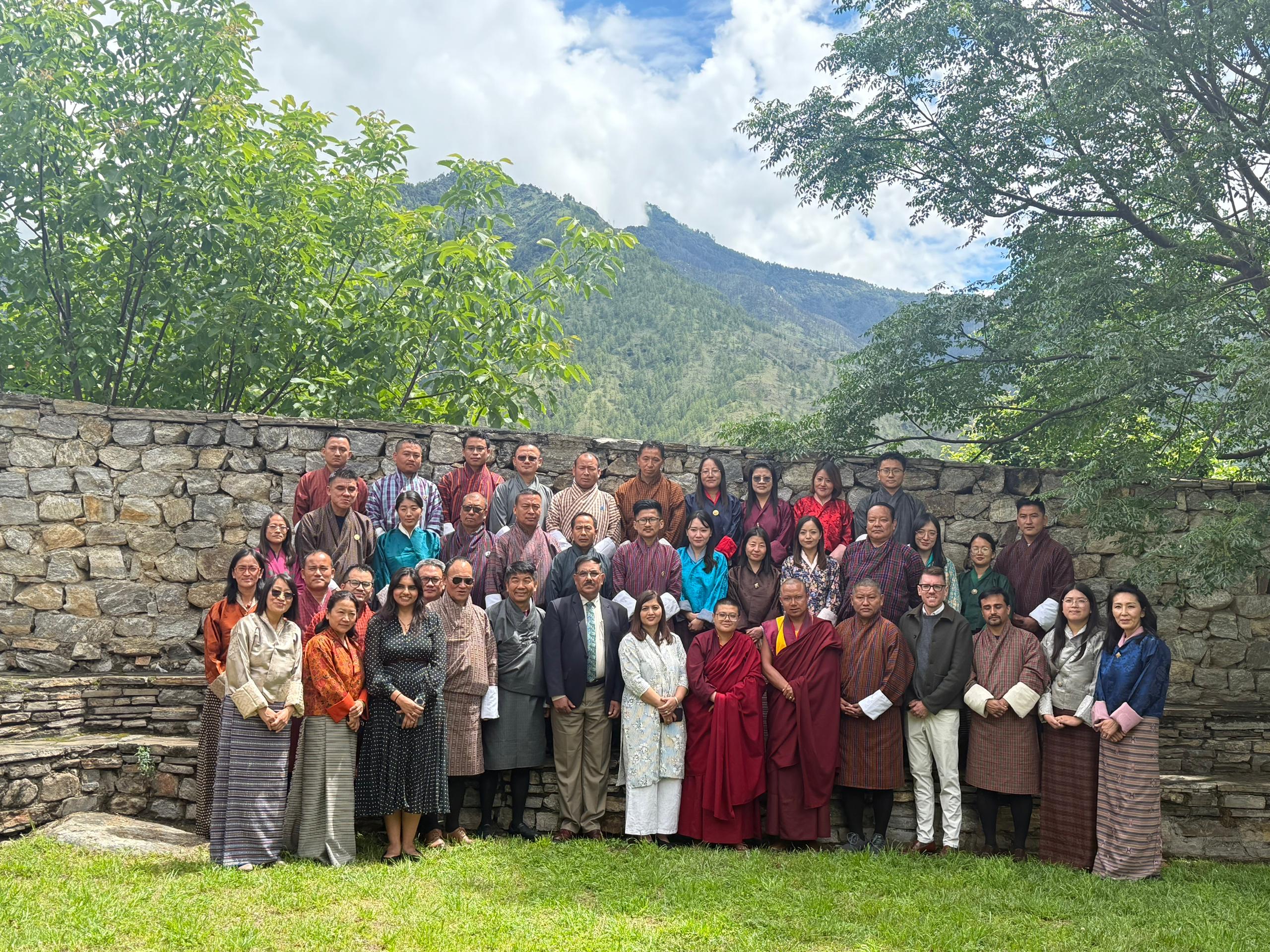 A group photo of people standing up outdoors