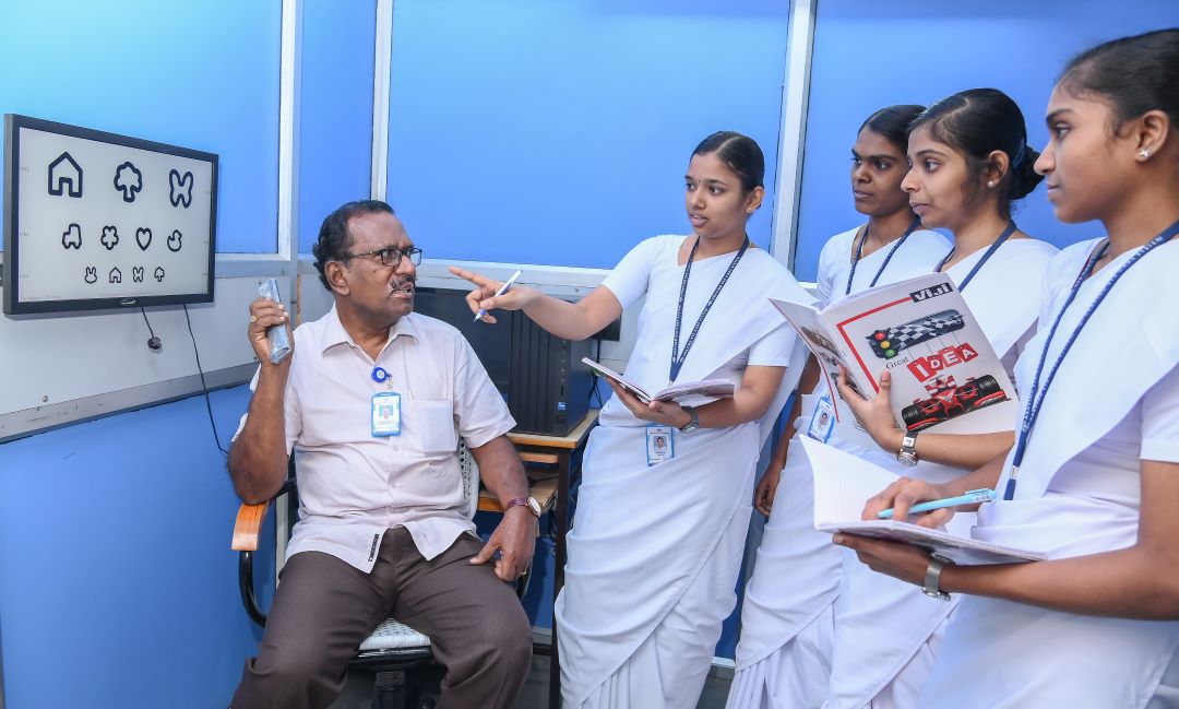 A community eye health worker with some medical students in a clinical setting