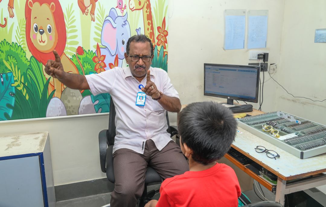 A community eye health worker performing an eye examination
