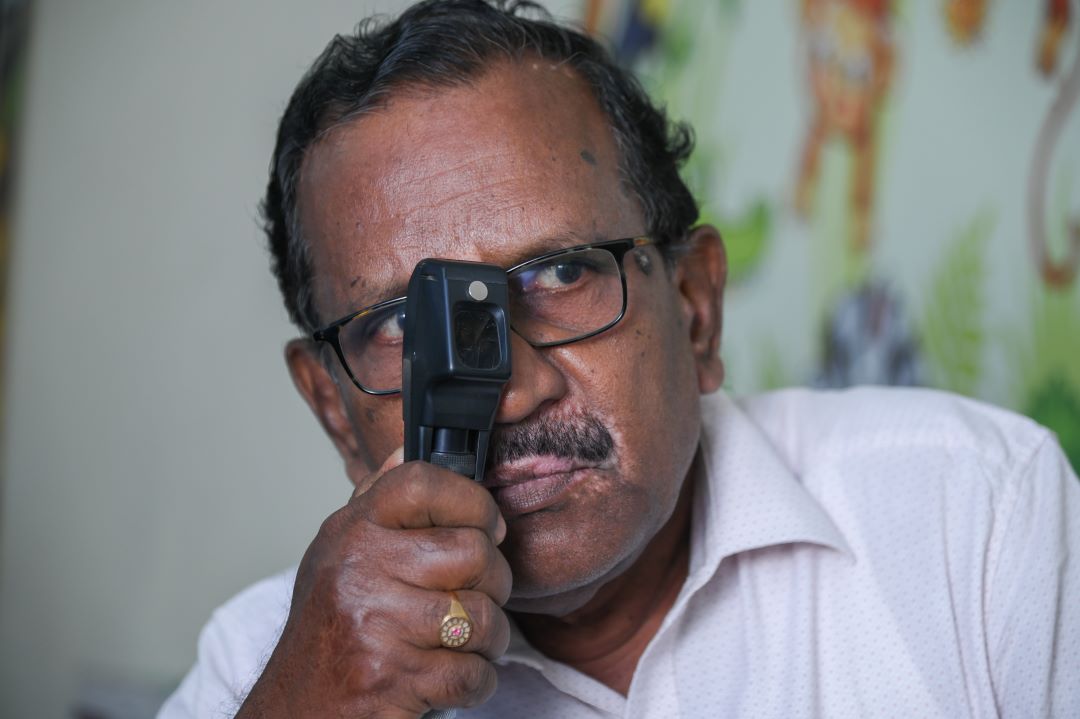 A eye community health worker perfroming an eye examination
