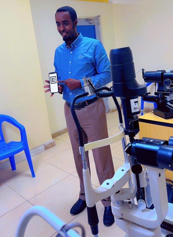 A man holding the WHOeyes app on his hands