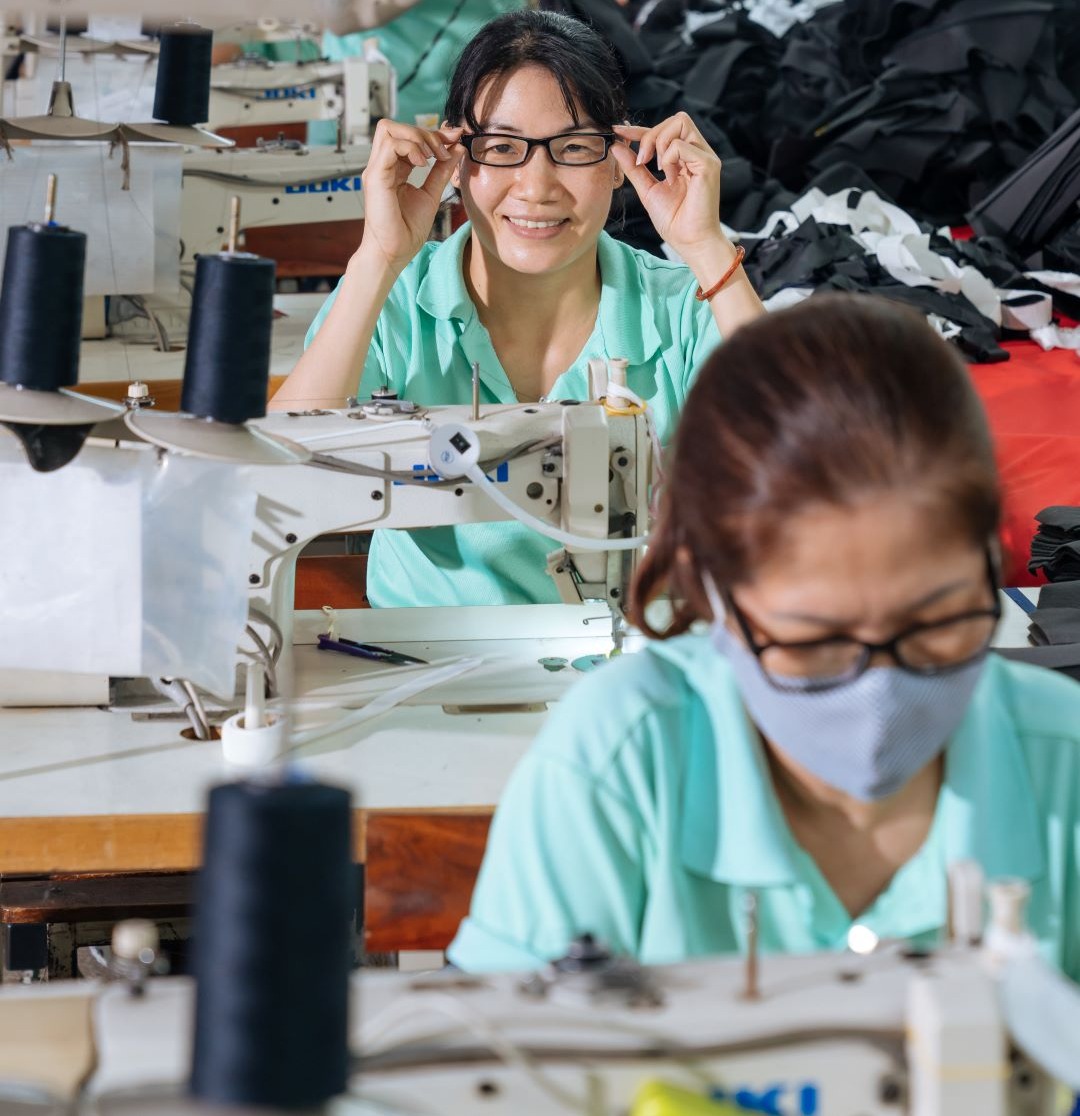 A group of women working in a factory with sewing machines