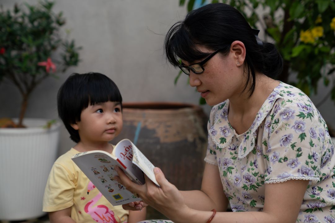A woman reading to her son