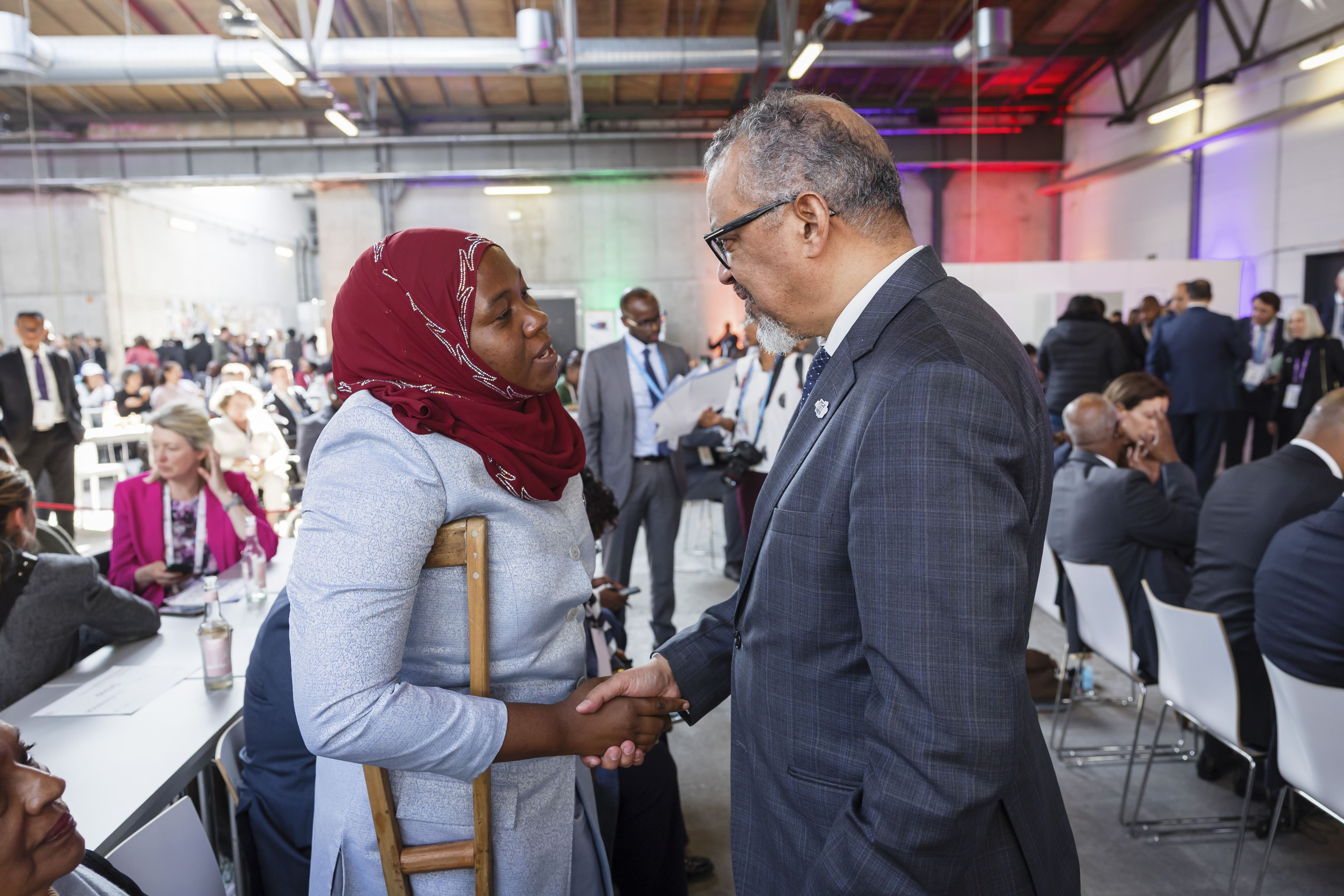 Dr Tedros shaking hands with a woman with disabilities at the Global Disability Summit 2025