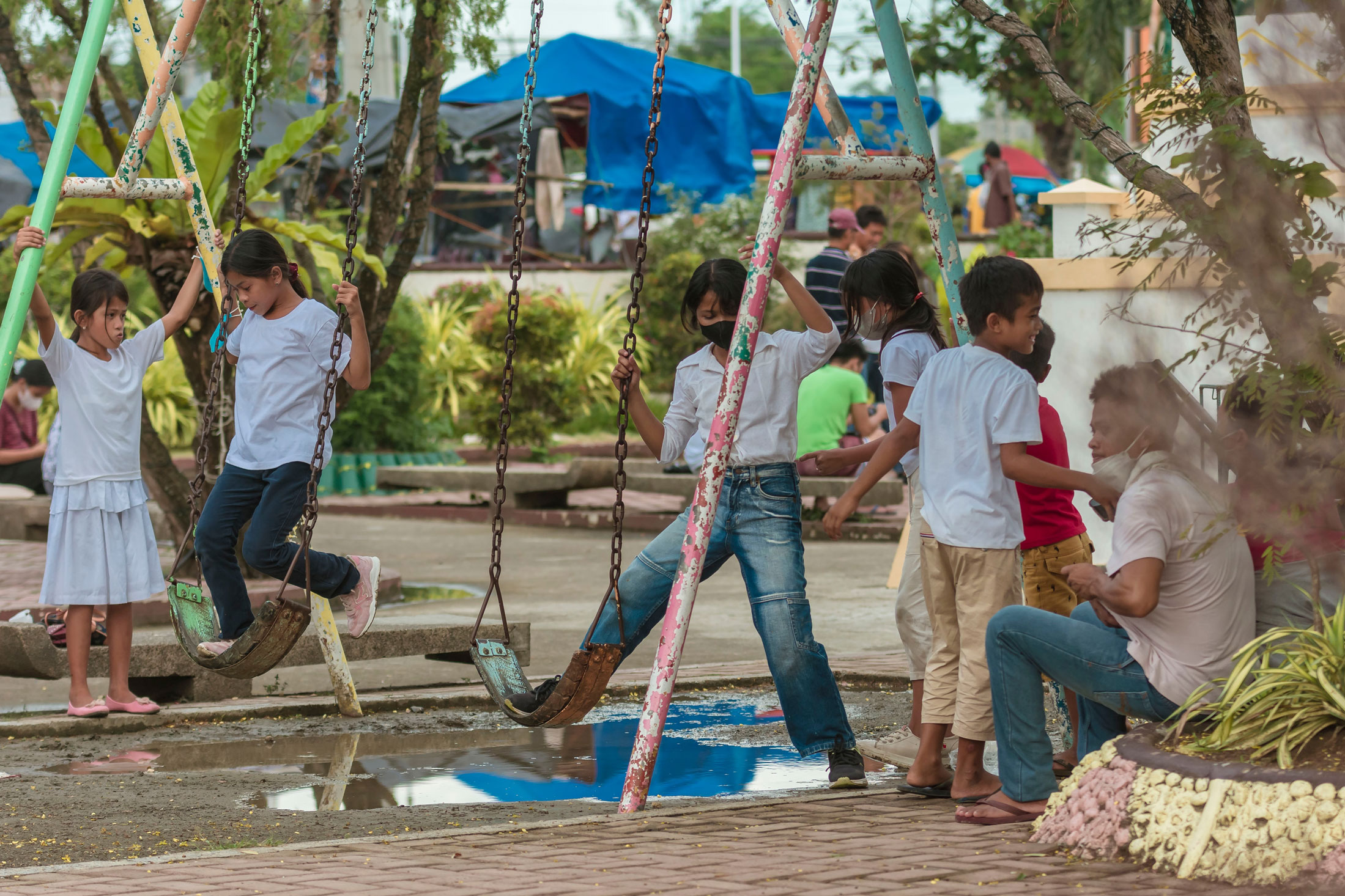 Playground in the Philippines Children playing on a swings at a playground
