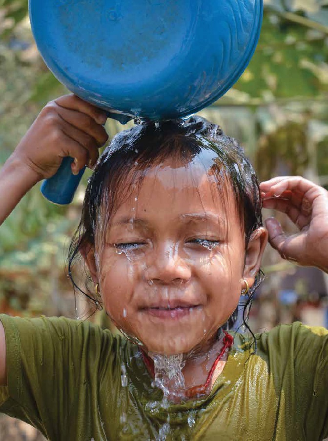 girl and water A smiling little girl pouring water on her head