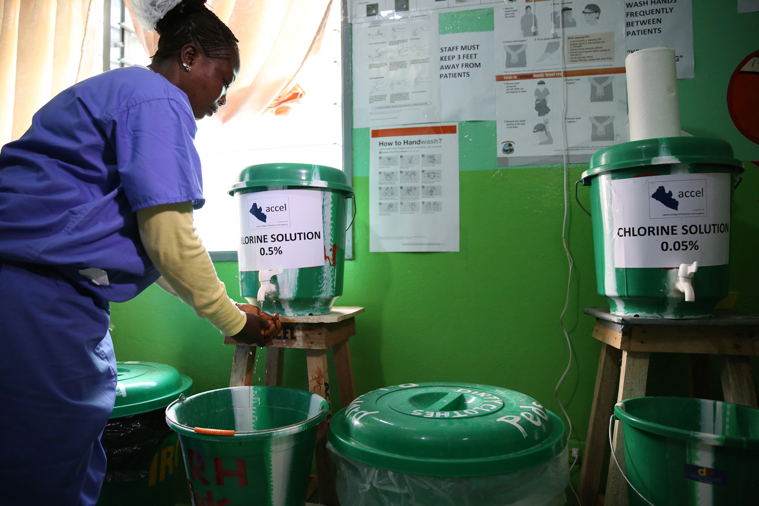 Garmai Garbo a nurse at Redemption Hospital washes her hands in Monrovia, Liberia