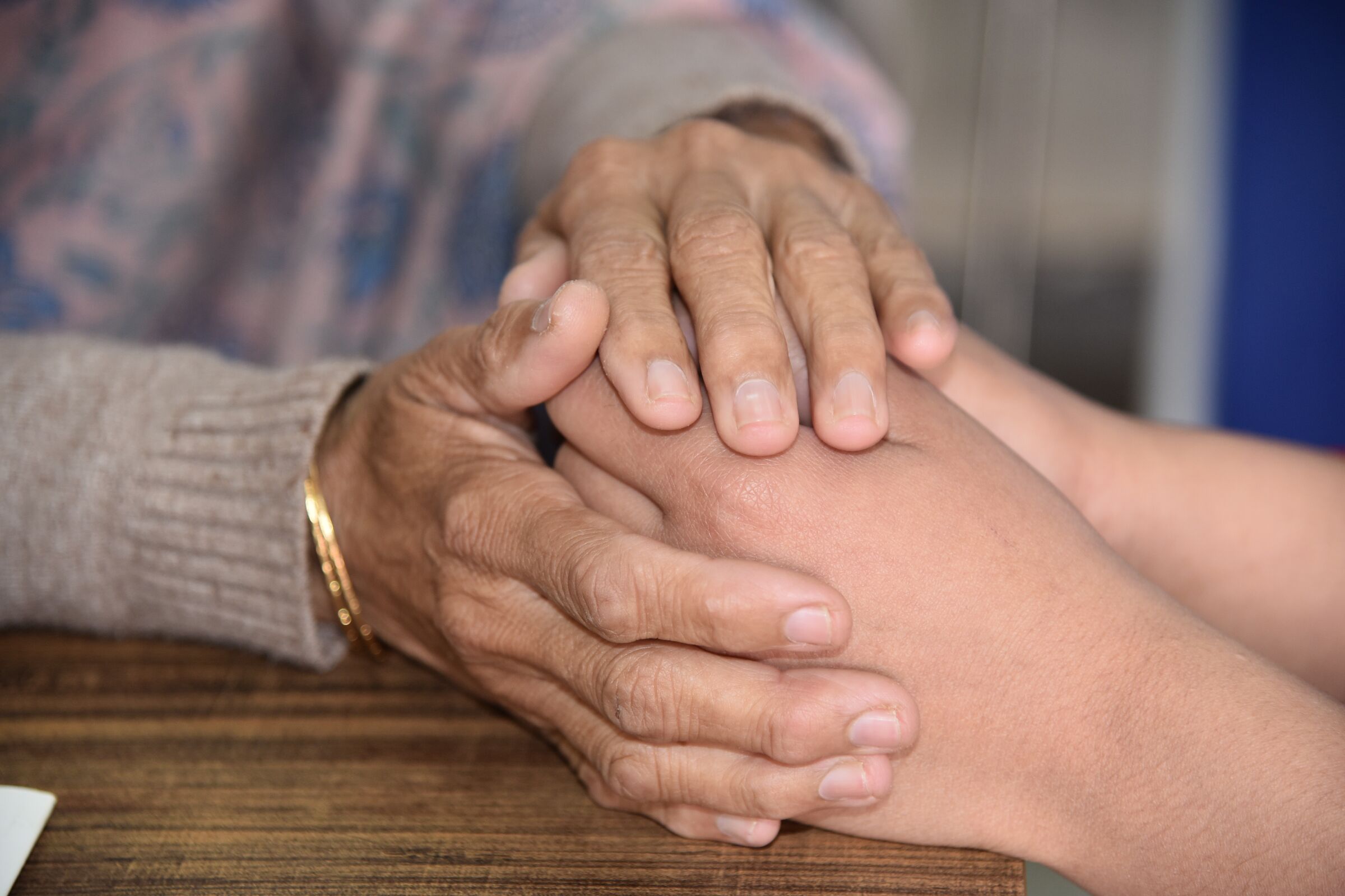 Hands holding another's hands, comforting and supporting.