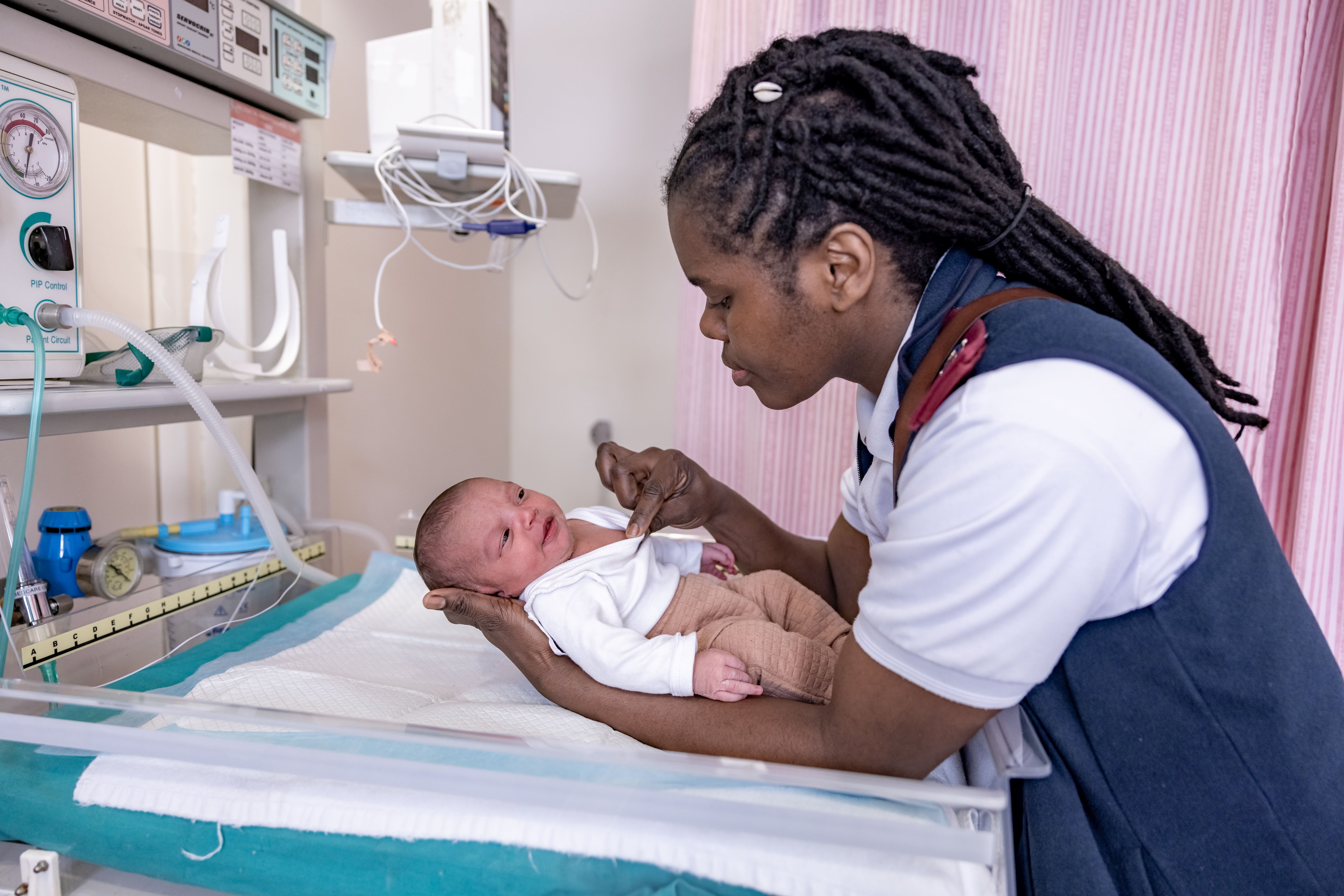 Midwife examines a baby Noxolo Hoga, Advanced Midwife, examines baby Naa-iqah Ragman in the labour ward at the Mitchells Plain District Hospital, Cape Town, South Africa.