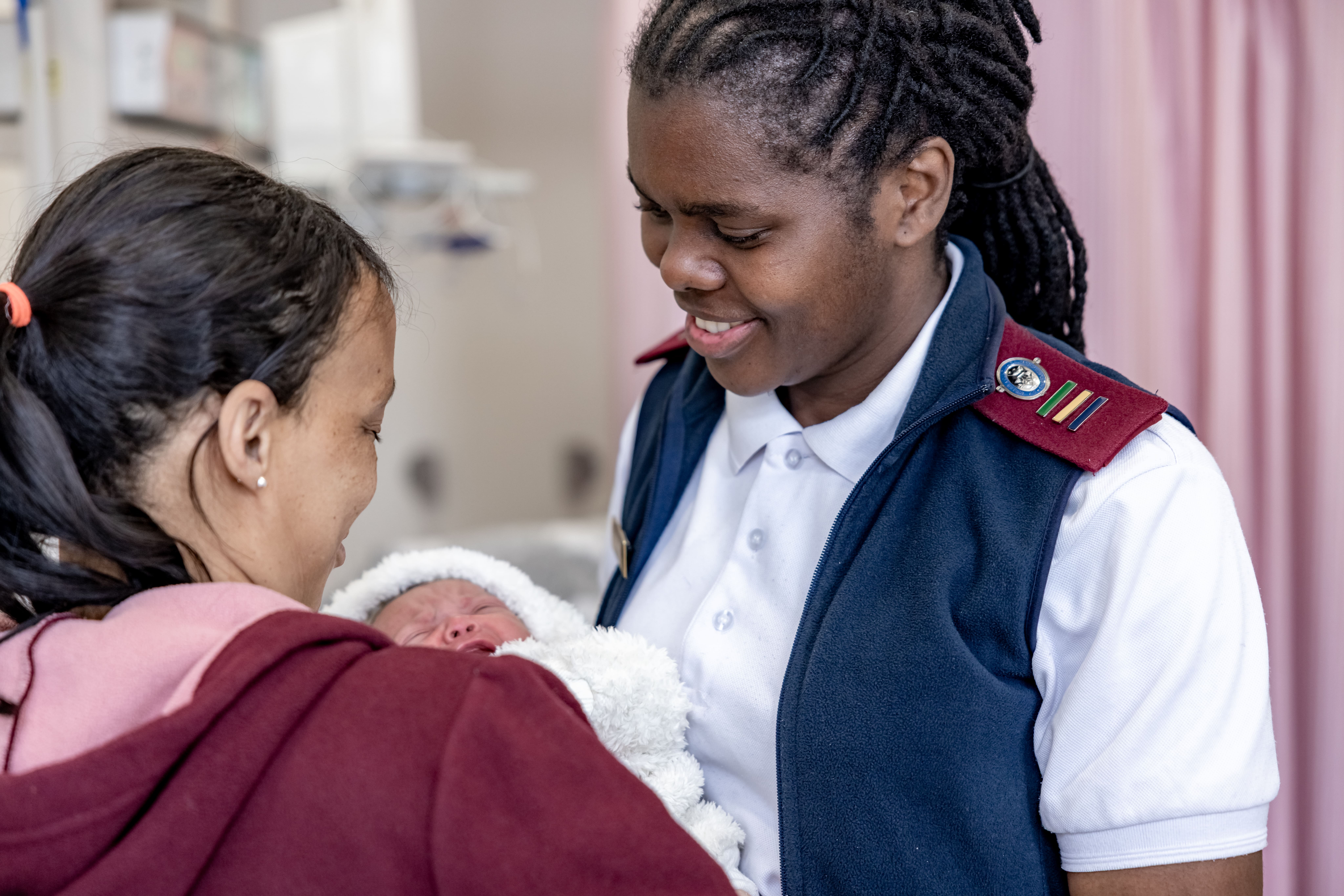 Midwife examines mother and baby Noxolo Hoga Advanced Midwife, examines Zaitoon Ragman and her baby, Naa-iqah (6 days old), in the labour ward at the Mitchells Plain District Hospital, Cape Town, South Africa.