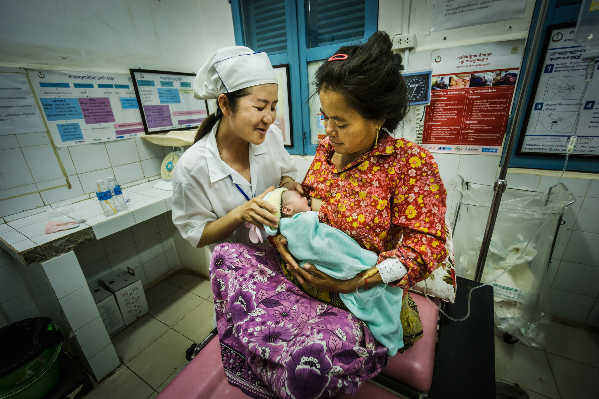 A nurse with a mother and her baby