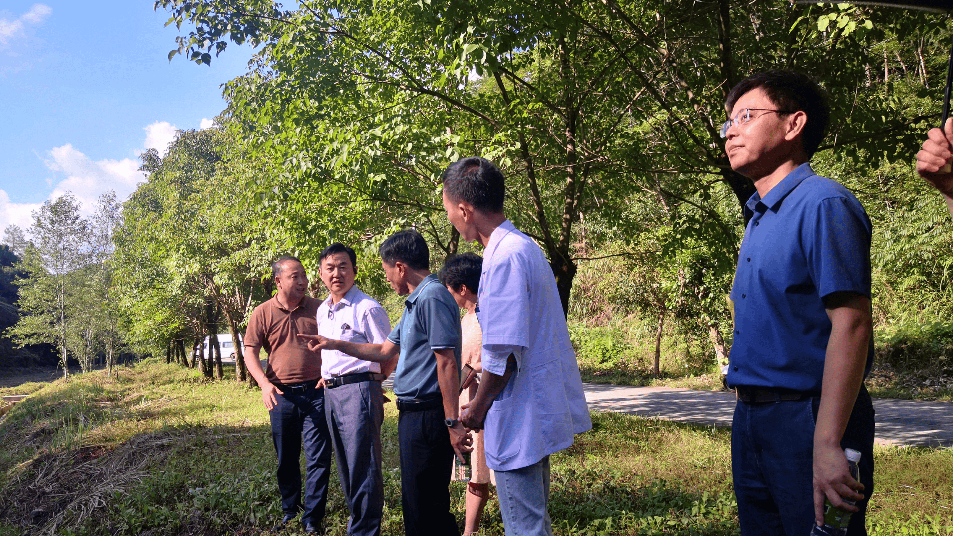 A group of people conversing surrounded by trees in China