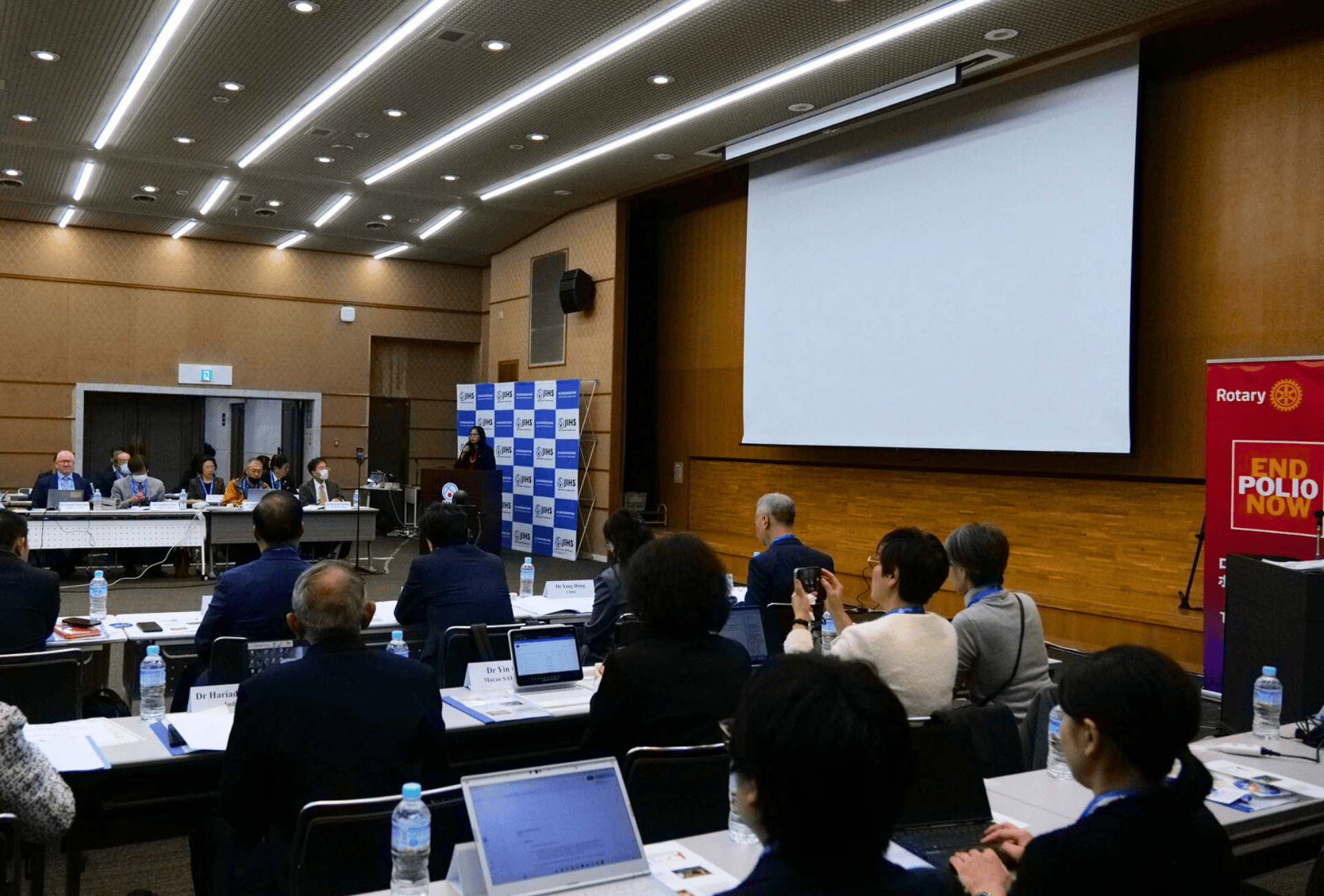 A group of people in a meeting on ending polio