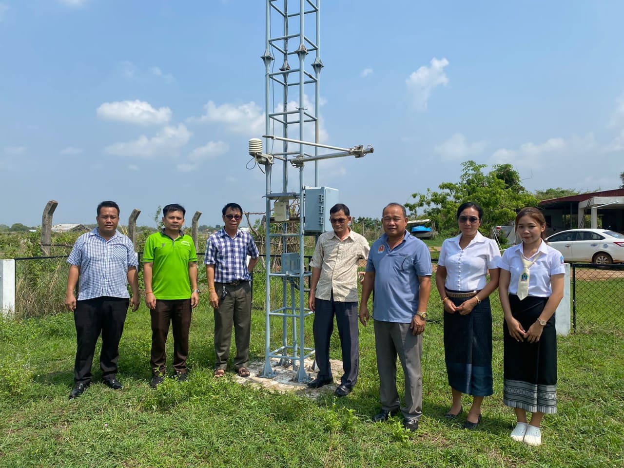 Local health and environment officials stading beside the air quality control sensors