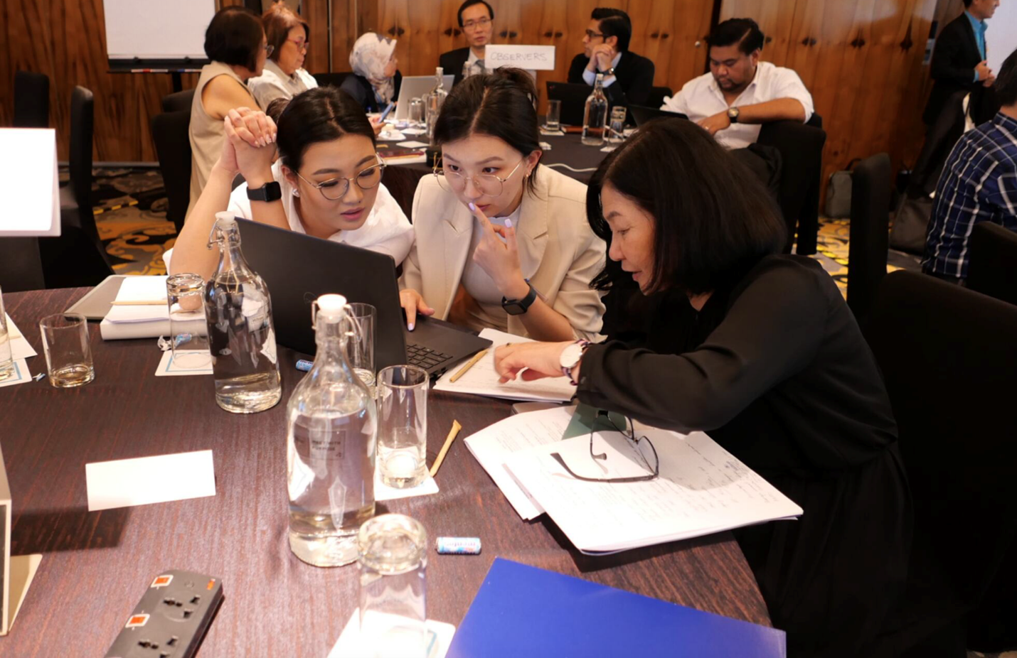 Delegates from Mongolia seated as they try the tool