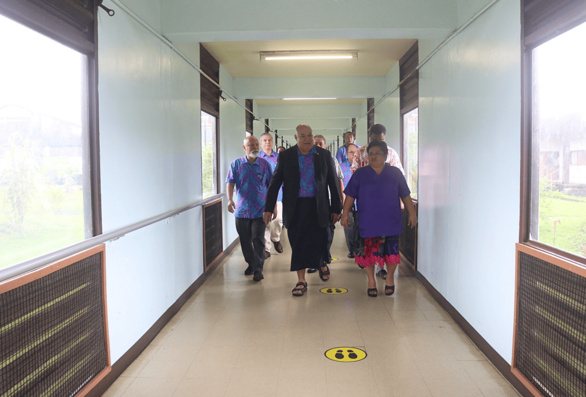 A group of people walking in a hospital hallway in Micronesia