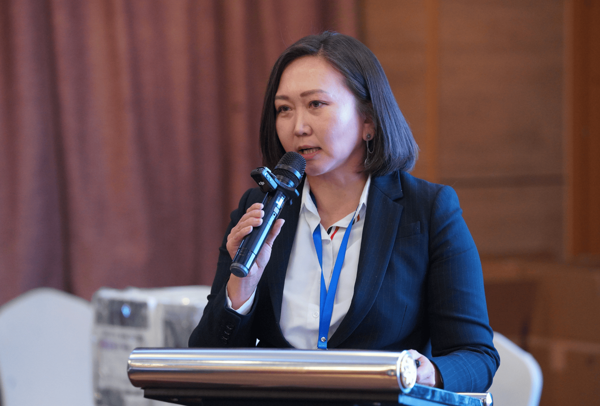 A woman speaking on a microphone