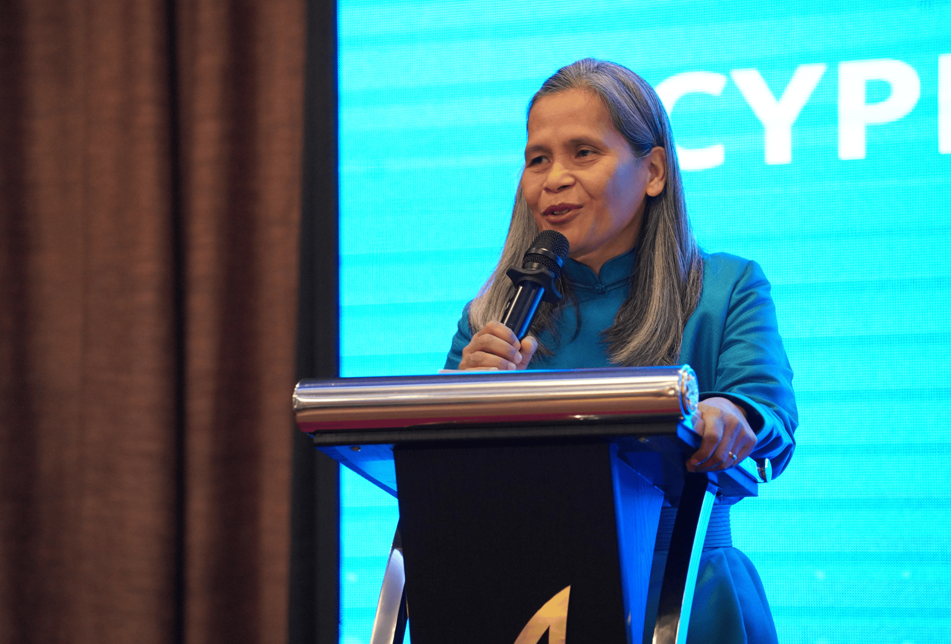 A woman speaking on a podium