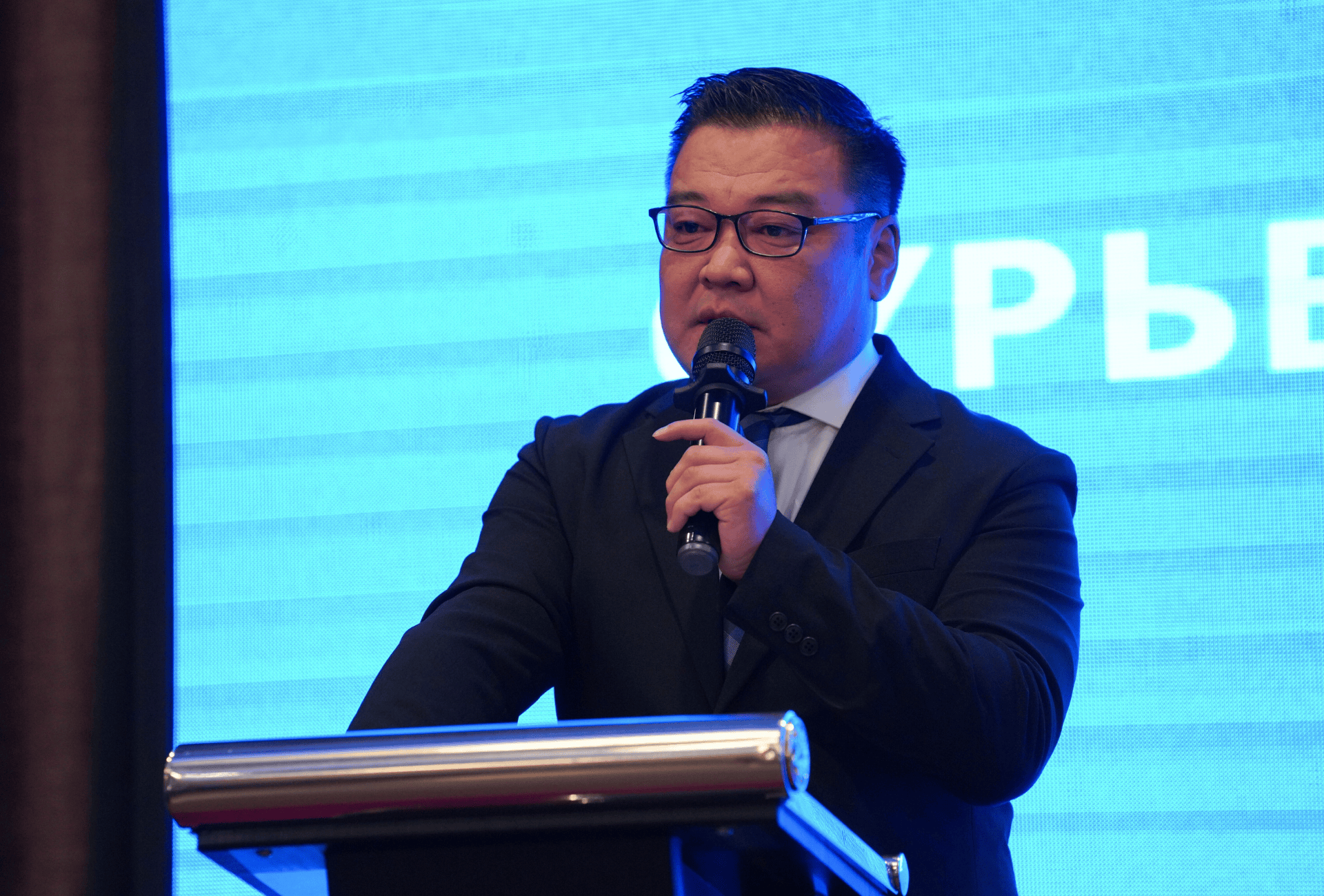 A man speaking on a podium