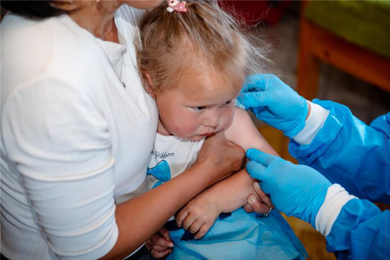 A young girl during her measles vaccination