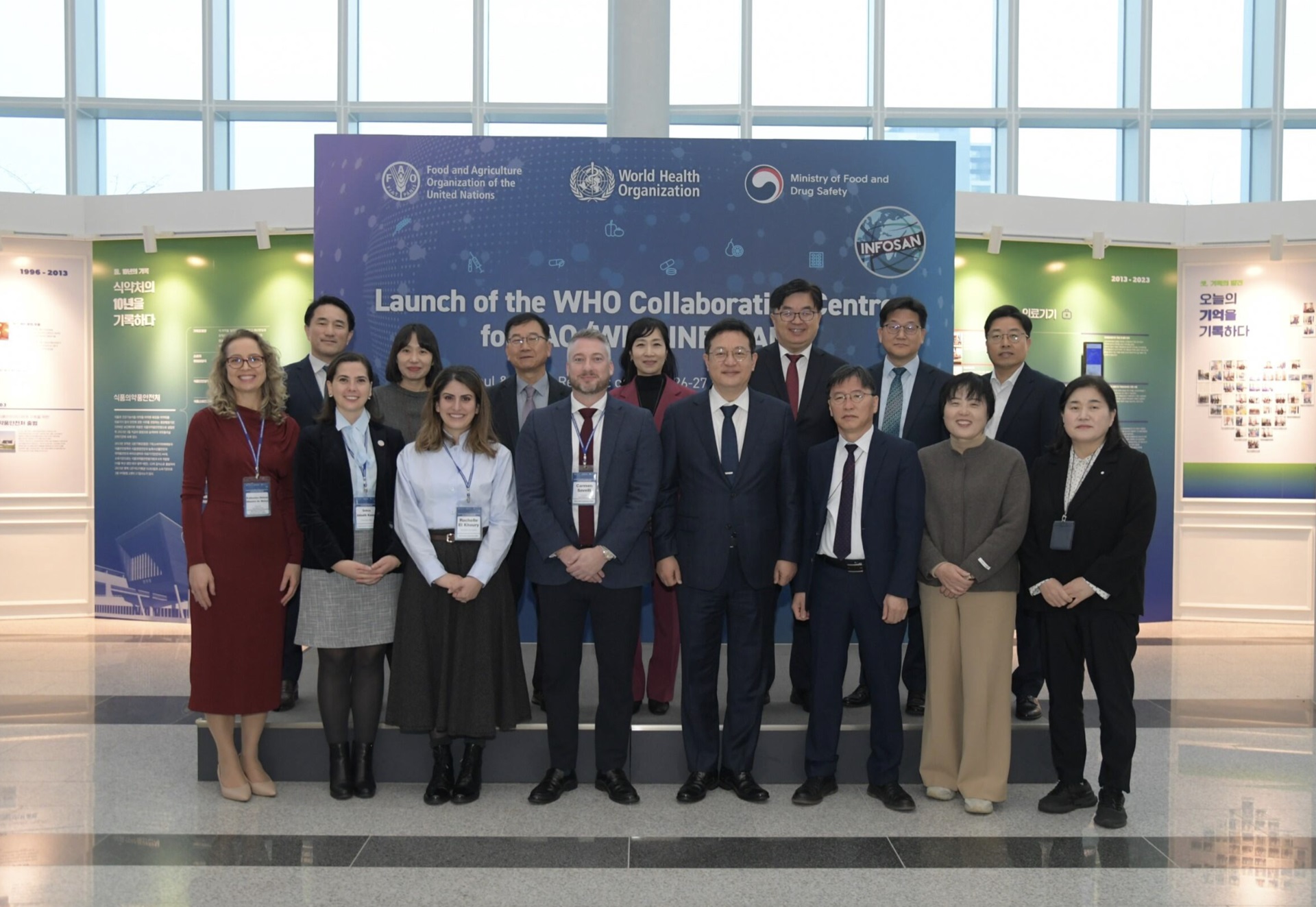 A group photo behind a sign that says launch of the WHO Collaborating Centre for FAO/WHO INFOSAN