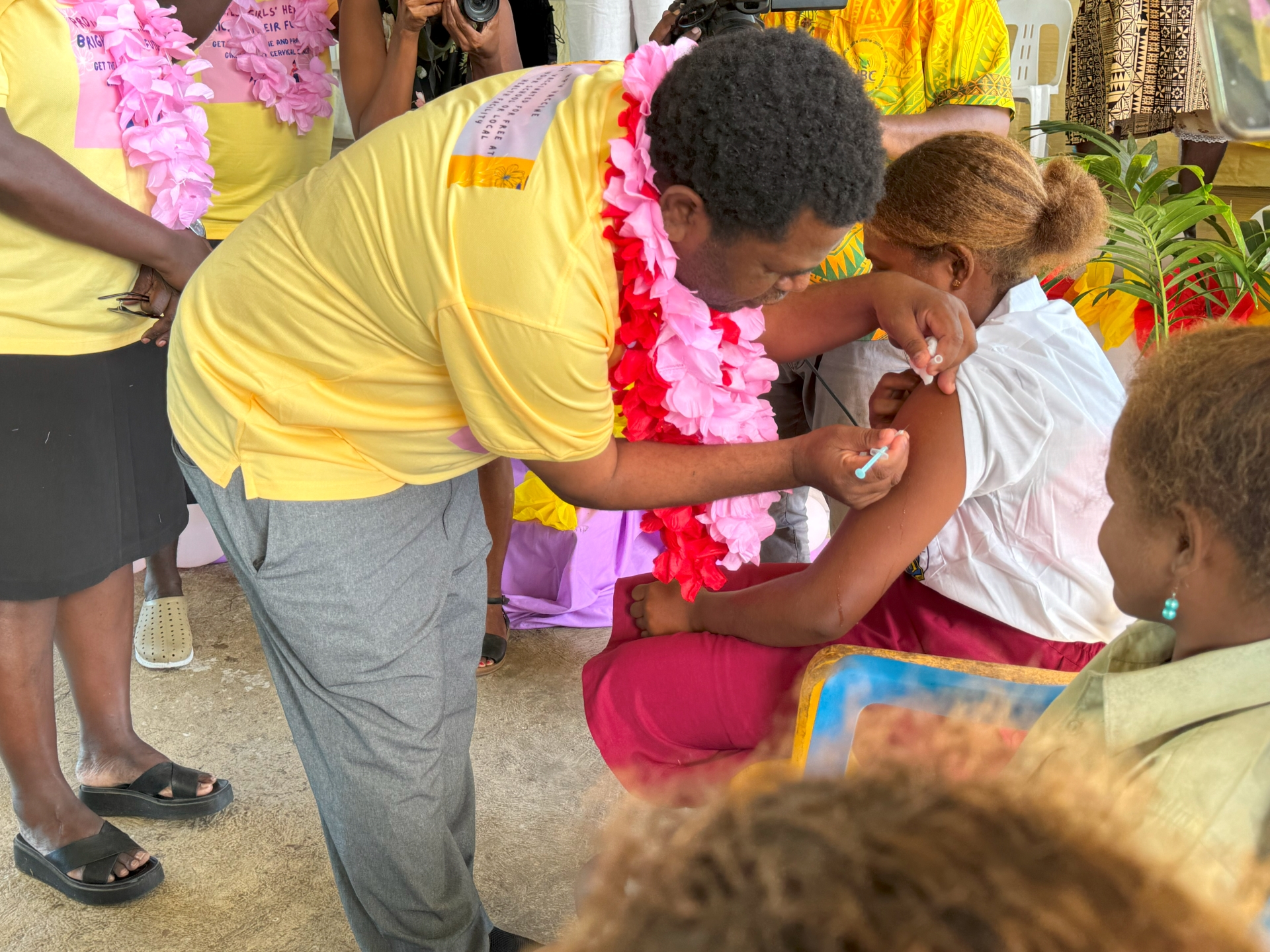 The Minister of Health and Medical Services administering the HPV vaccine.