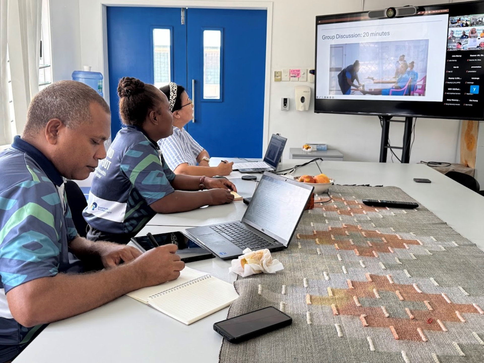 A group of facilitators listening to a presentation.