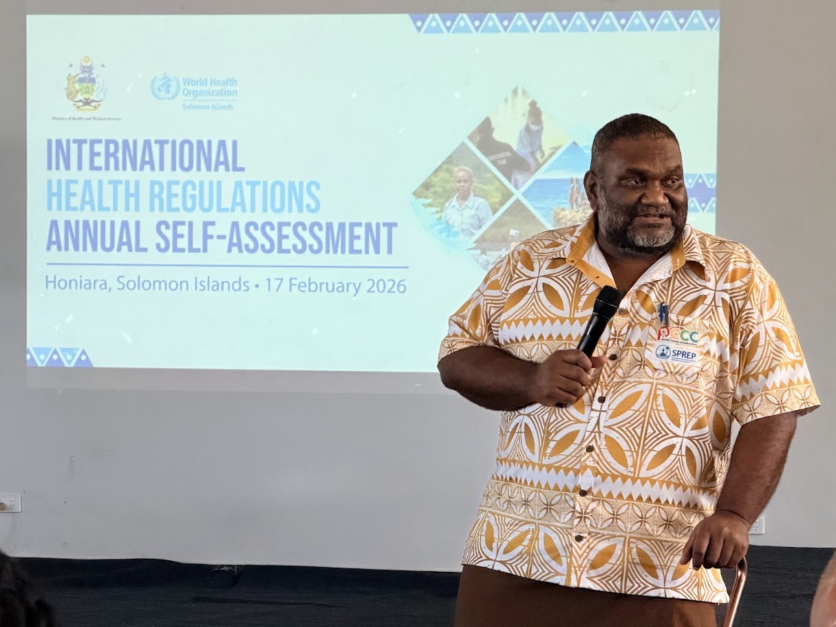 A man speaking at a workshop.
